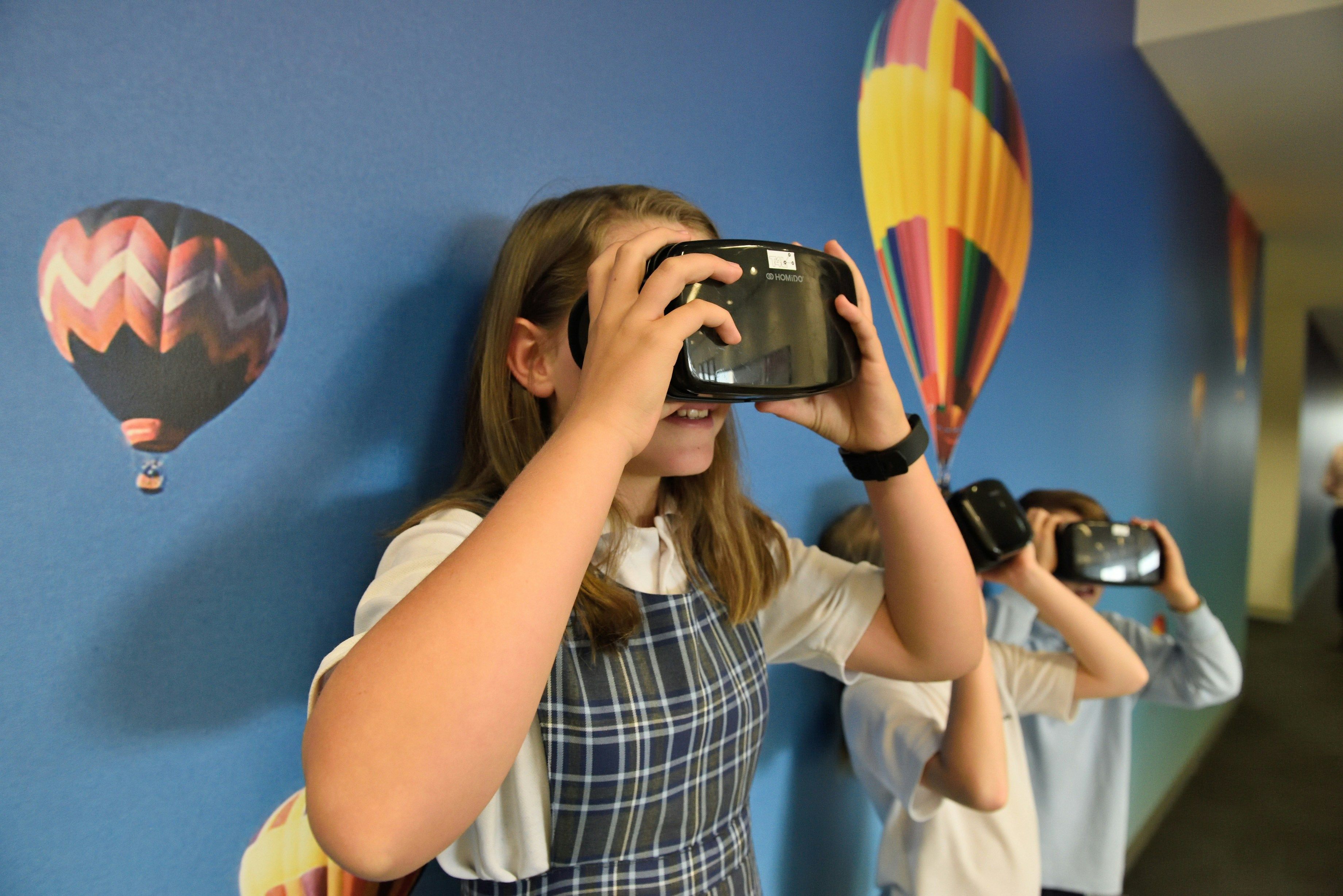 A middle school girl wearing a VR headset