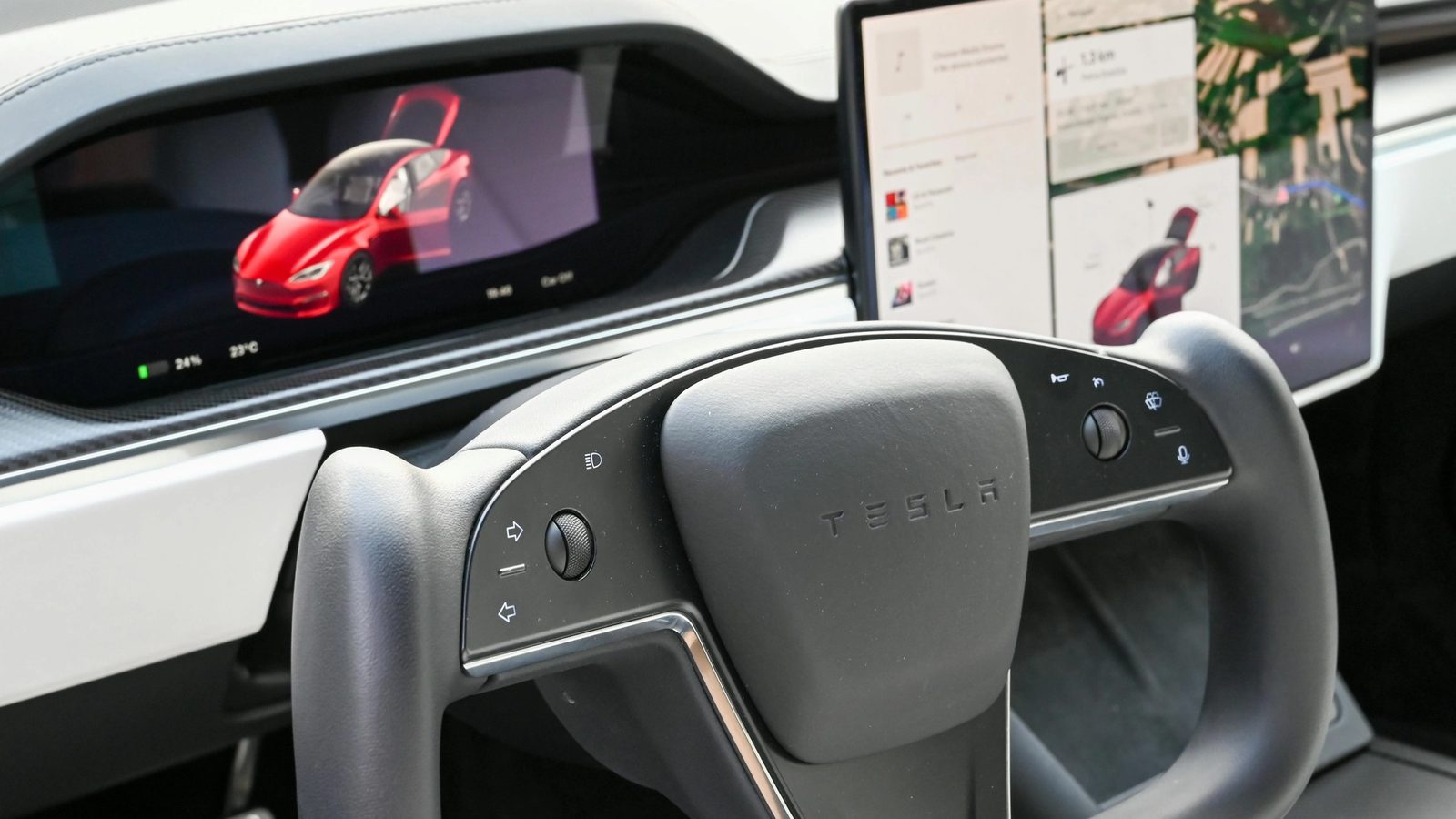 Main Image: Interior of a Tesla car showing the dashboard