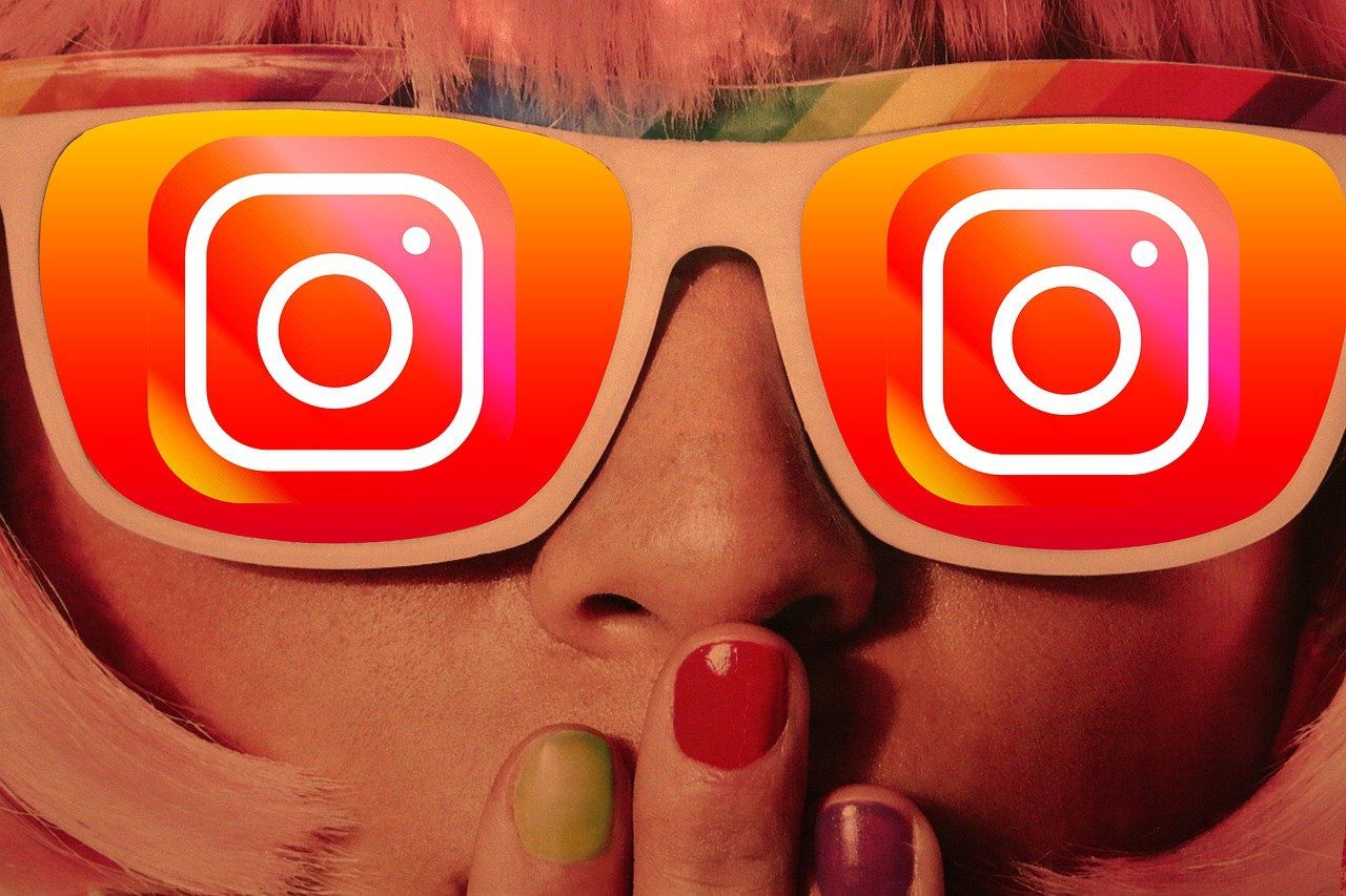 A girl wearing Instagram themed glasses