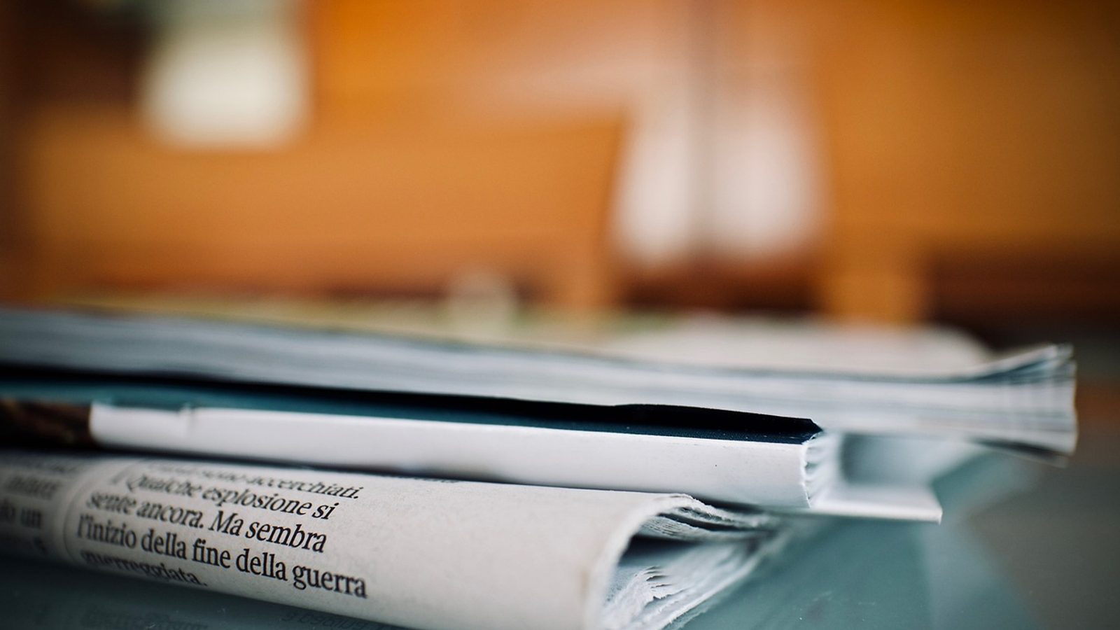 Main Image: A stack of newspapers