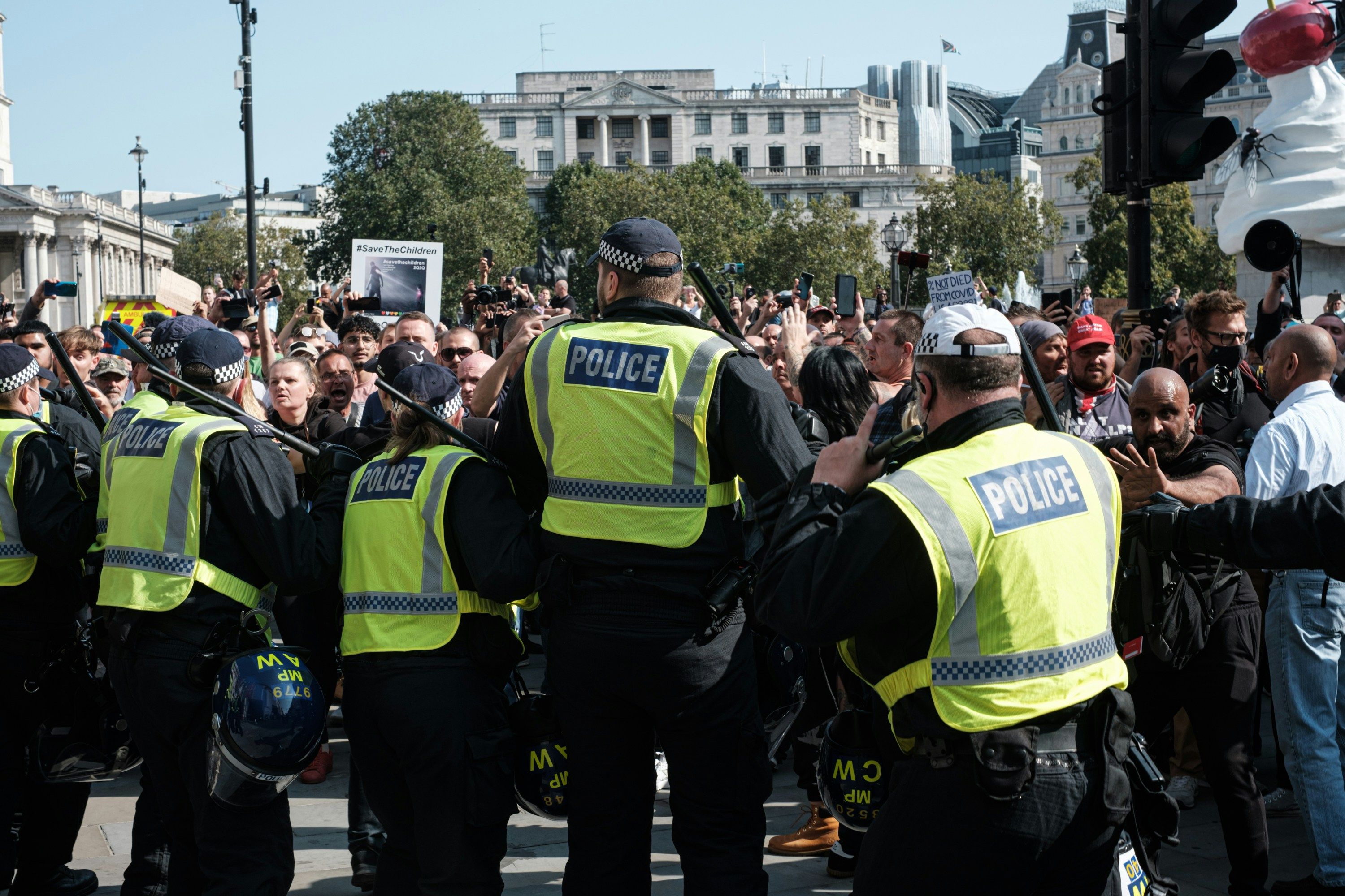 Policemen block rioters from progressing in London