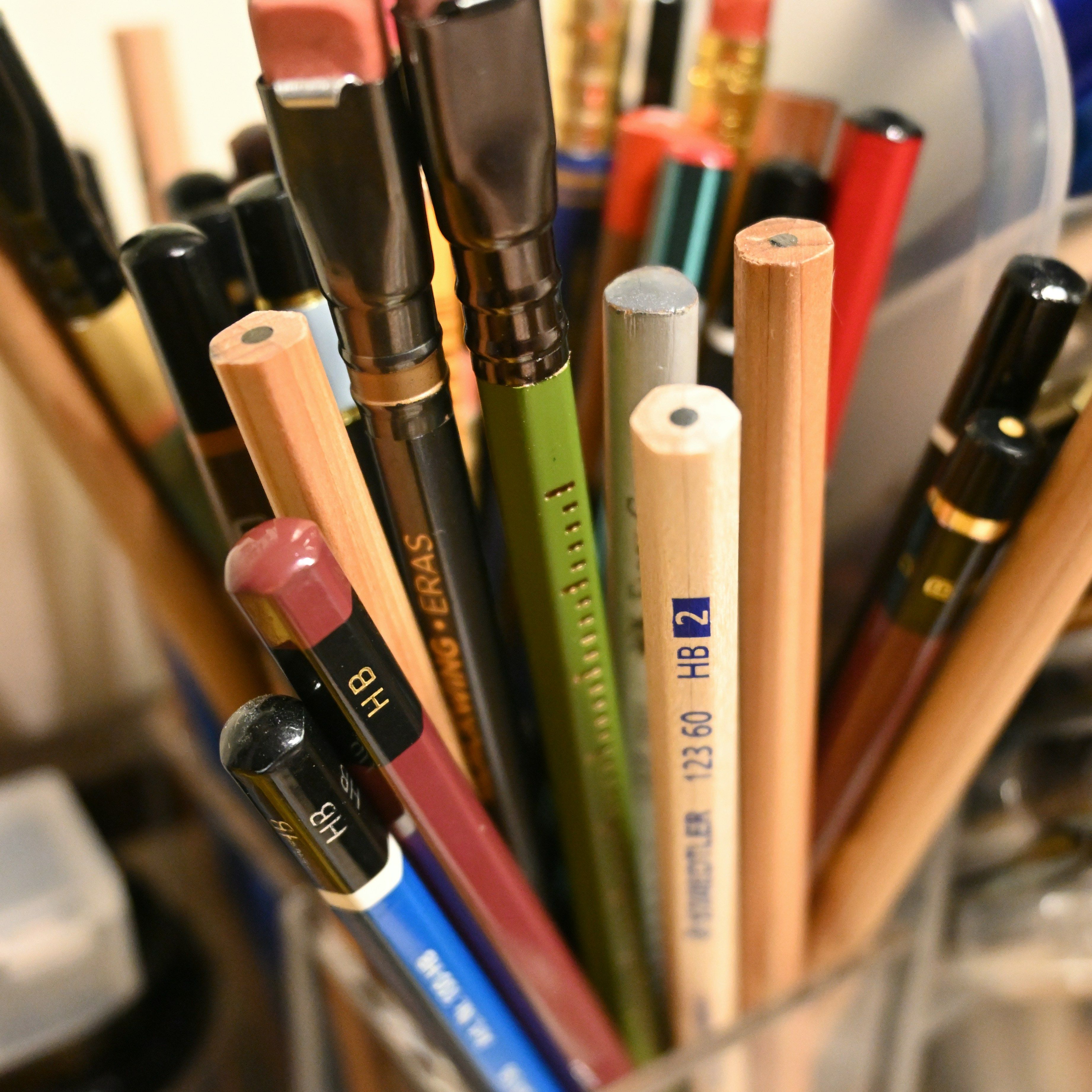 A pencil holder with several pens