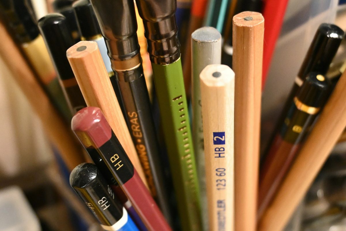 A pencil holder with several pens