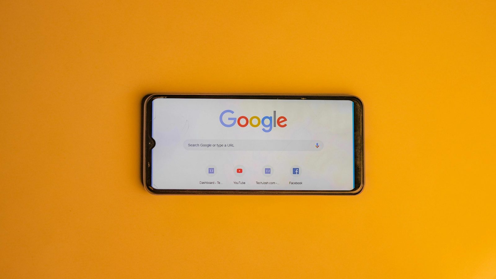 Main Image: Smart Phone with a Google Search Page on its Display