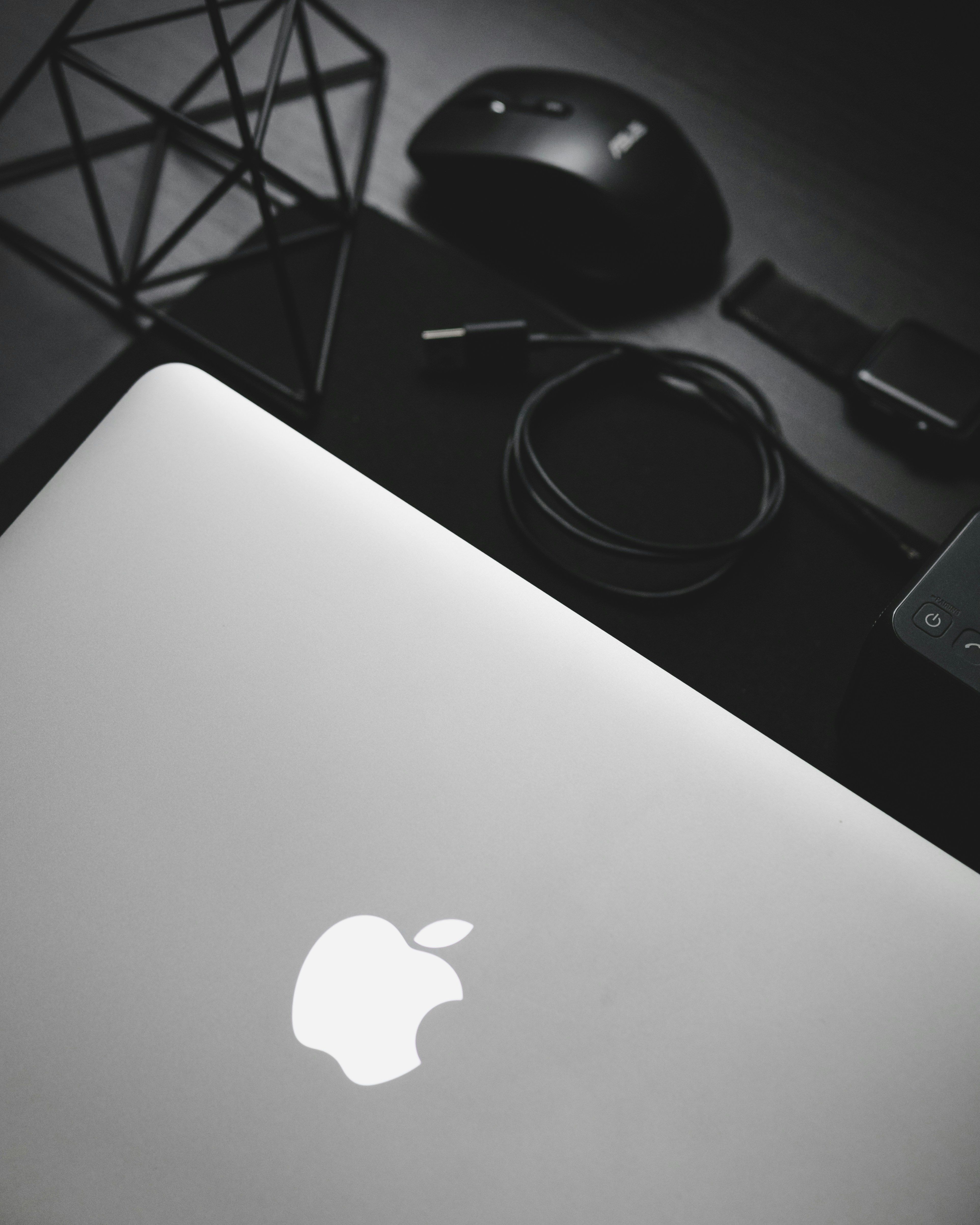 MacBook near a black computer mouse.