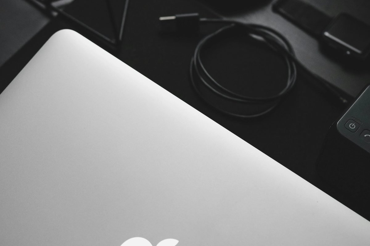 MacBook near a black computer mouse.