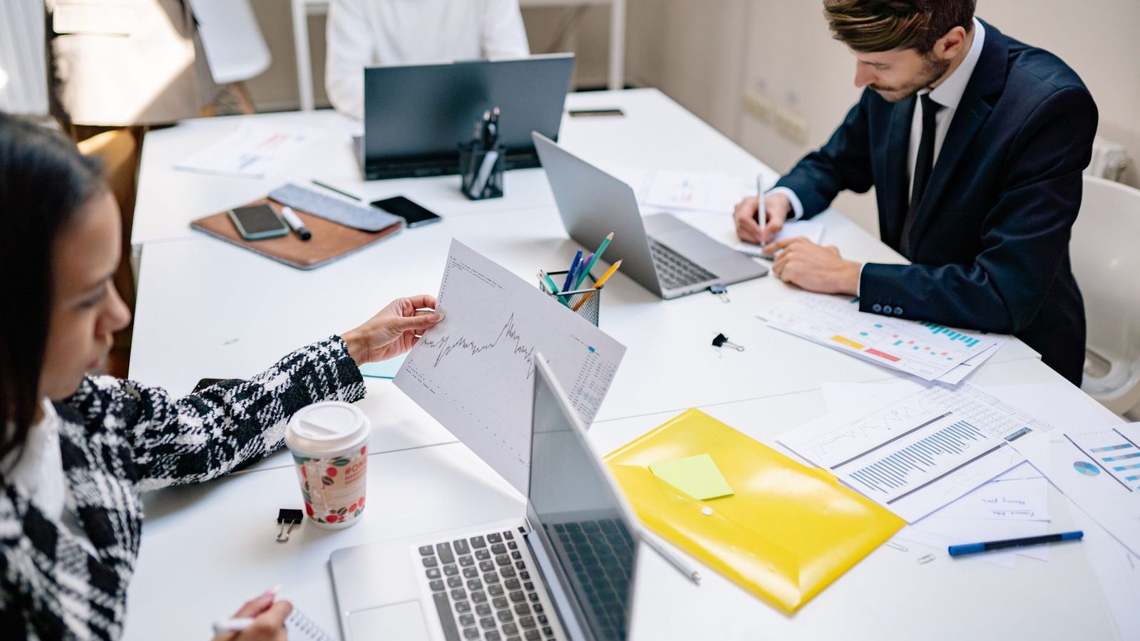 A marketing team working together on laptops