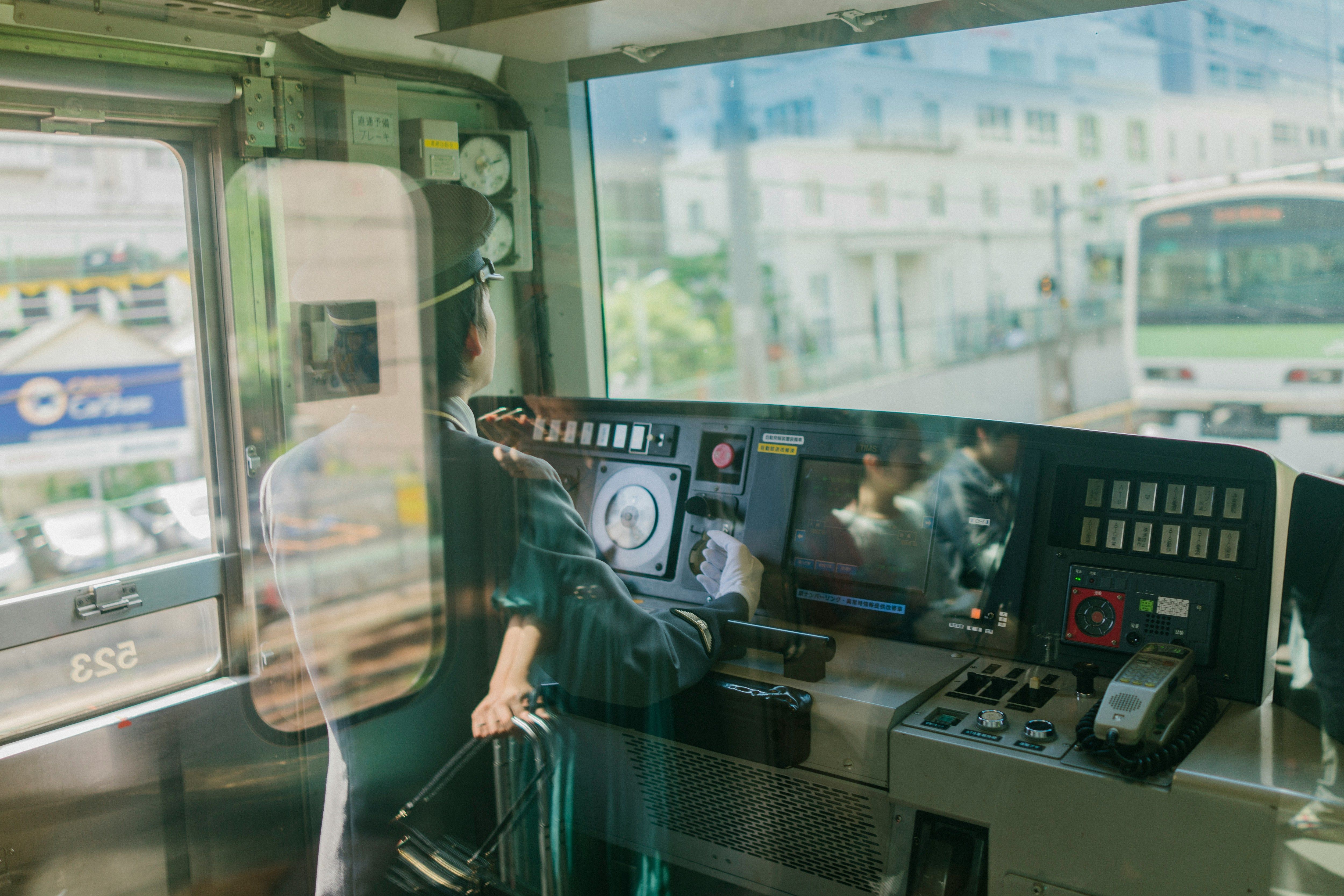 Man inside a train control panel booth