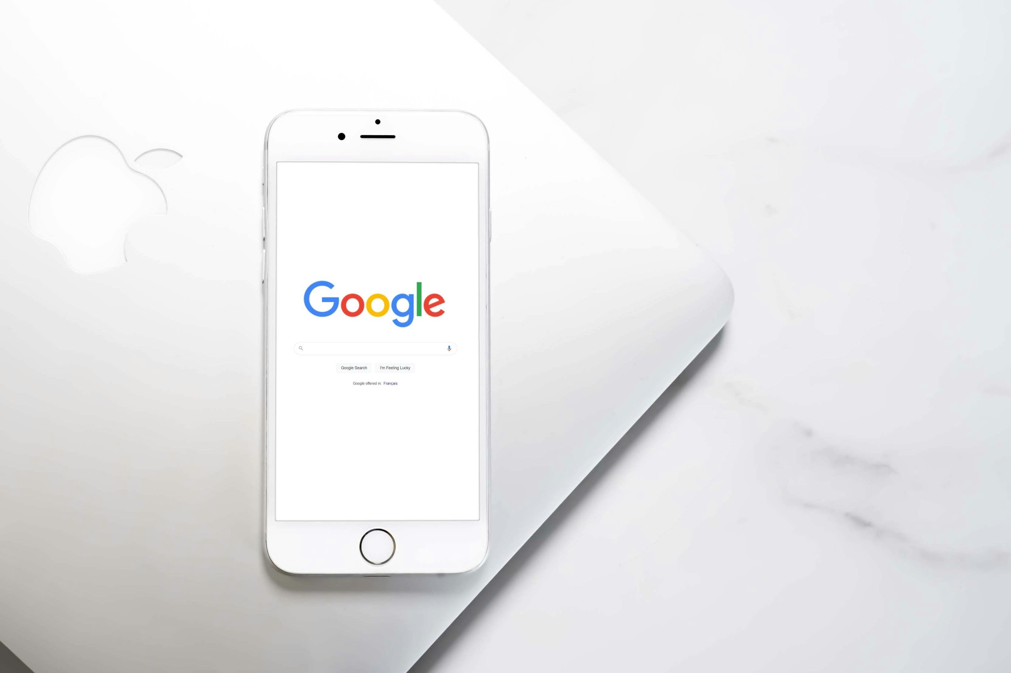 A white mobile phone with Google Search