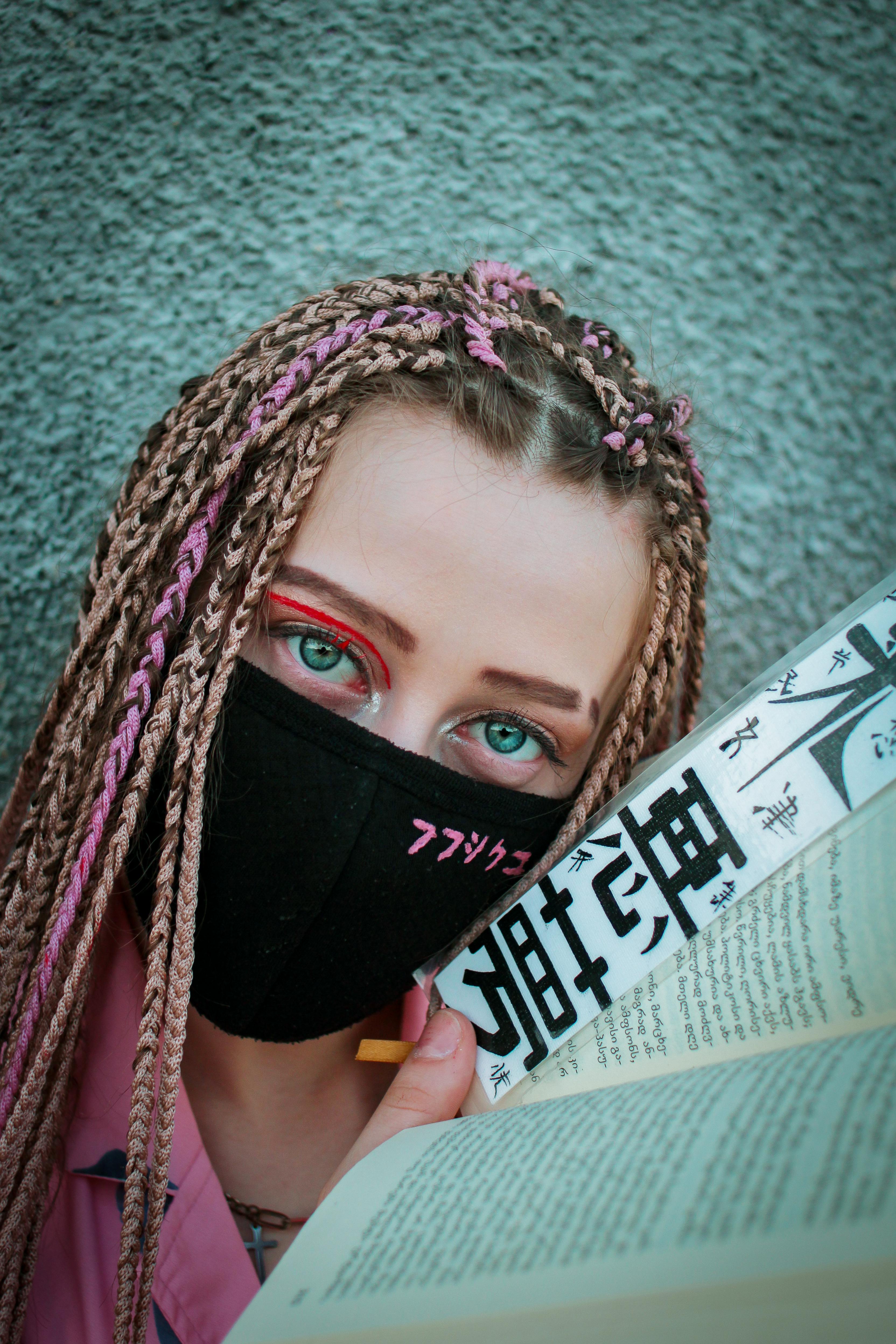 modern woman in safety mask with book