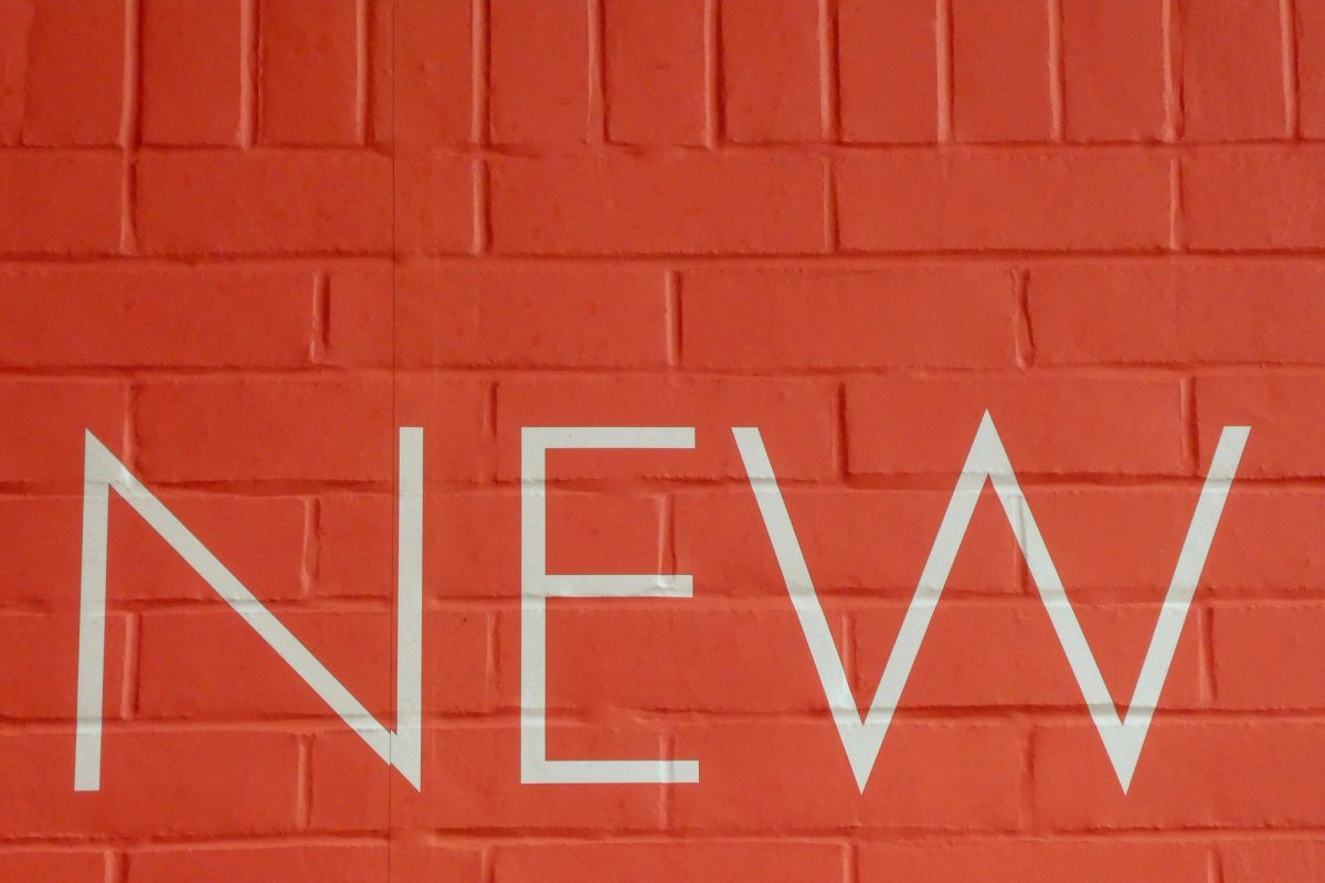 Word 'New' written on a red wall