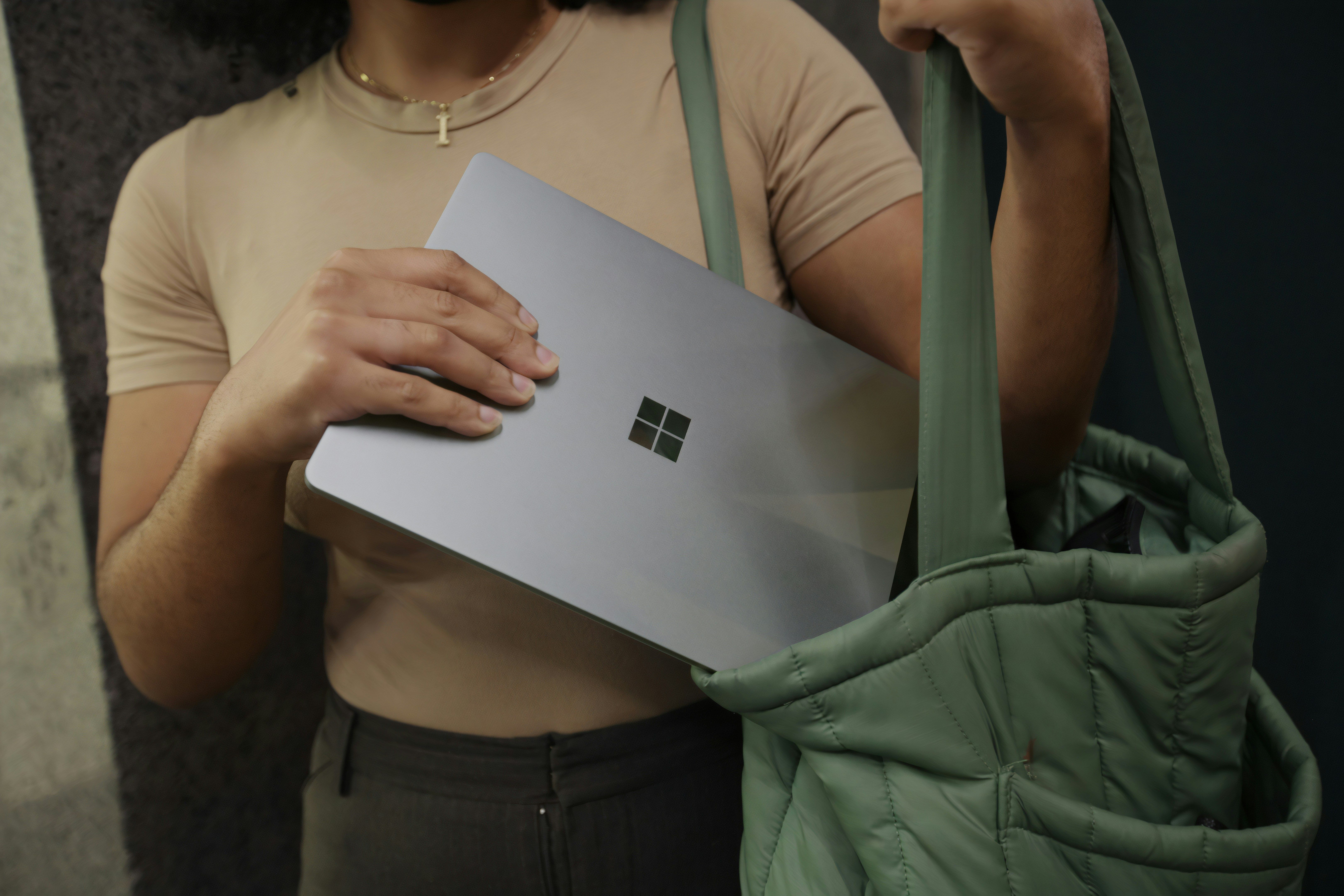 A lady putting her Microsoft Surface laptop inside her bag