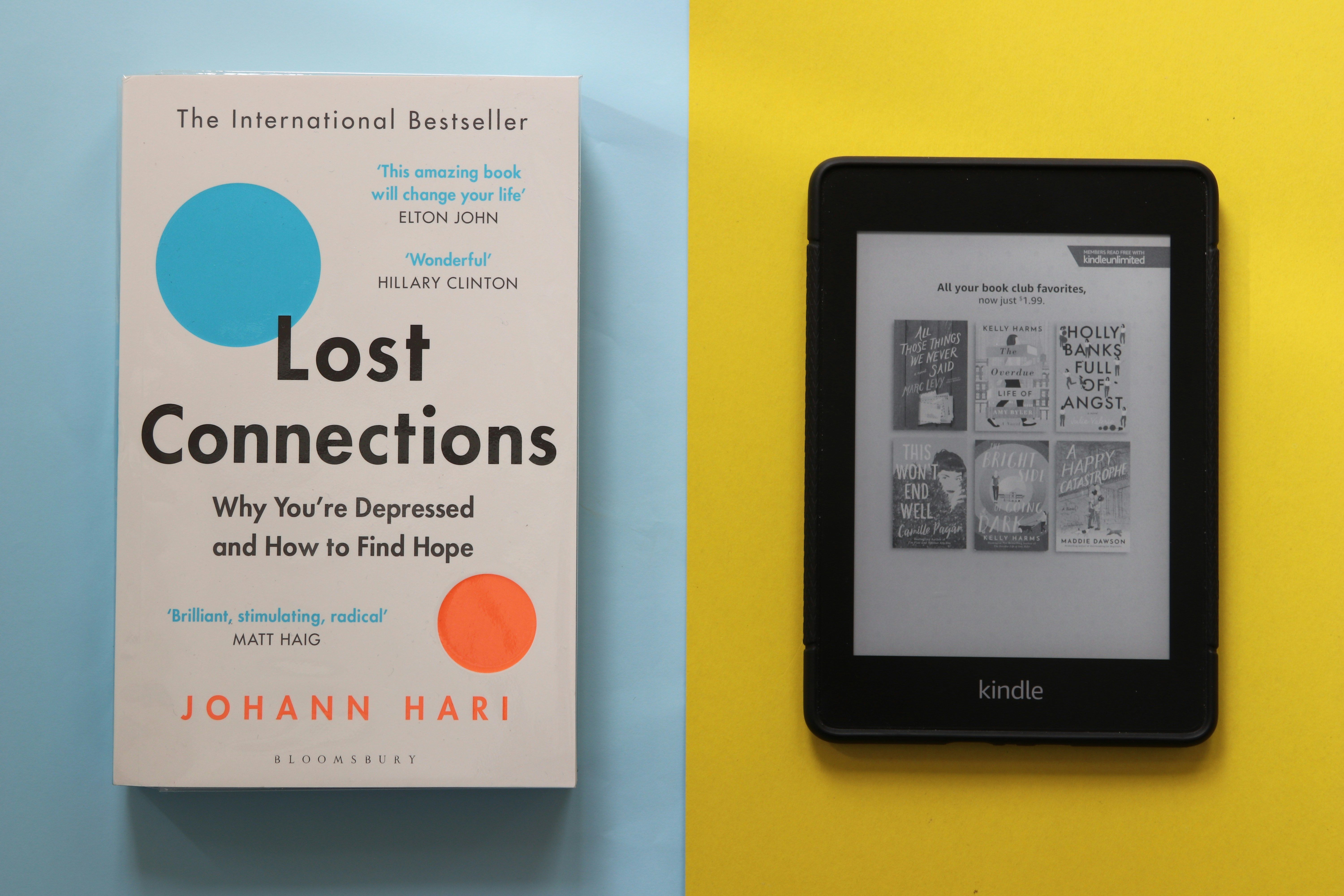 Main Image:  A book (Lost Connections by Johann Hari) and a black Amazon Kindle