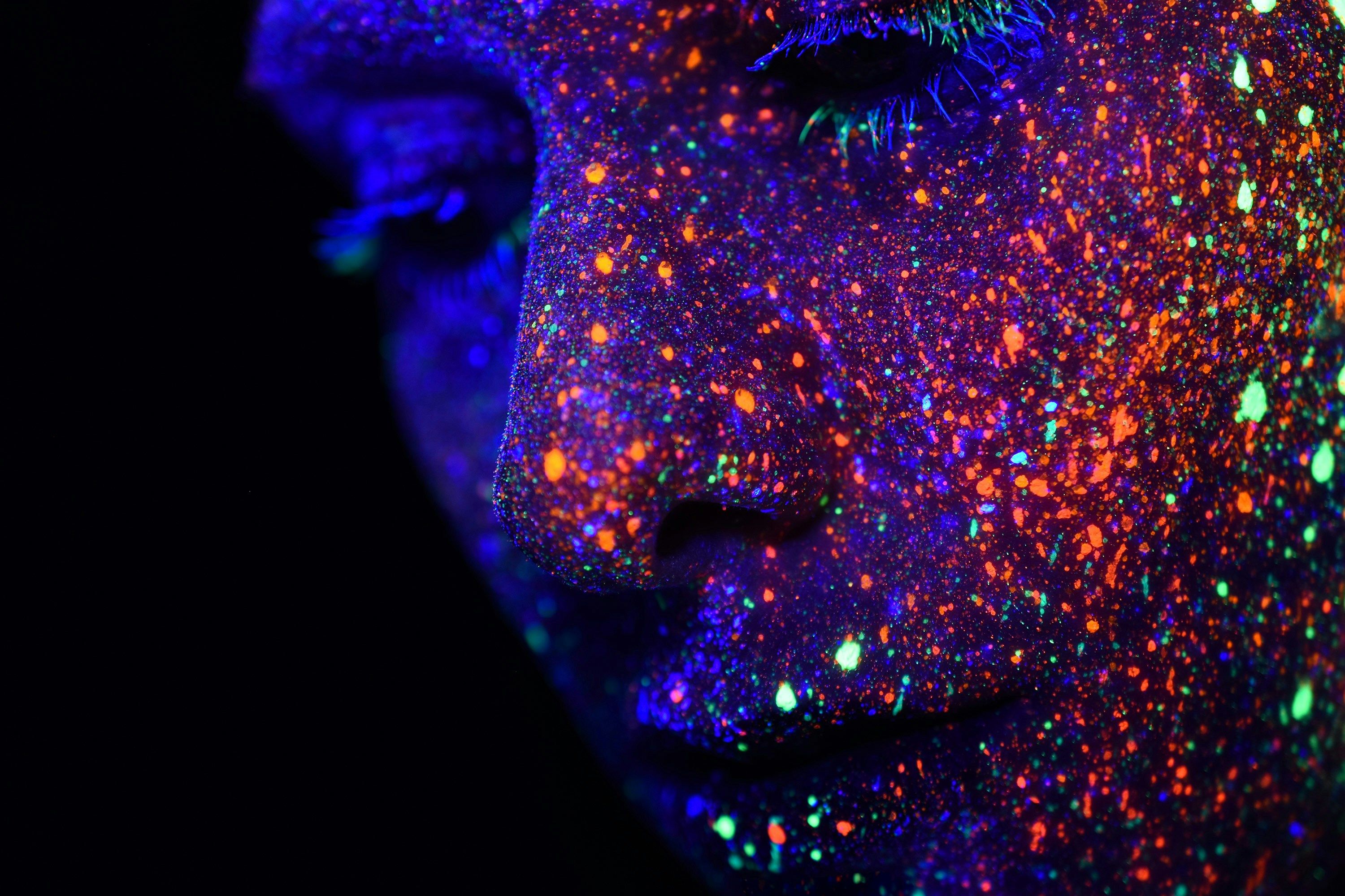 Person with an assortment of colors painted on their face