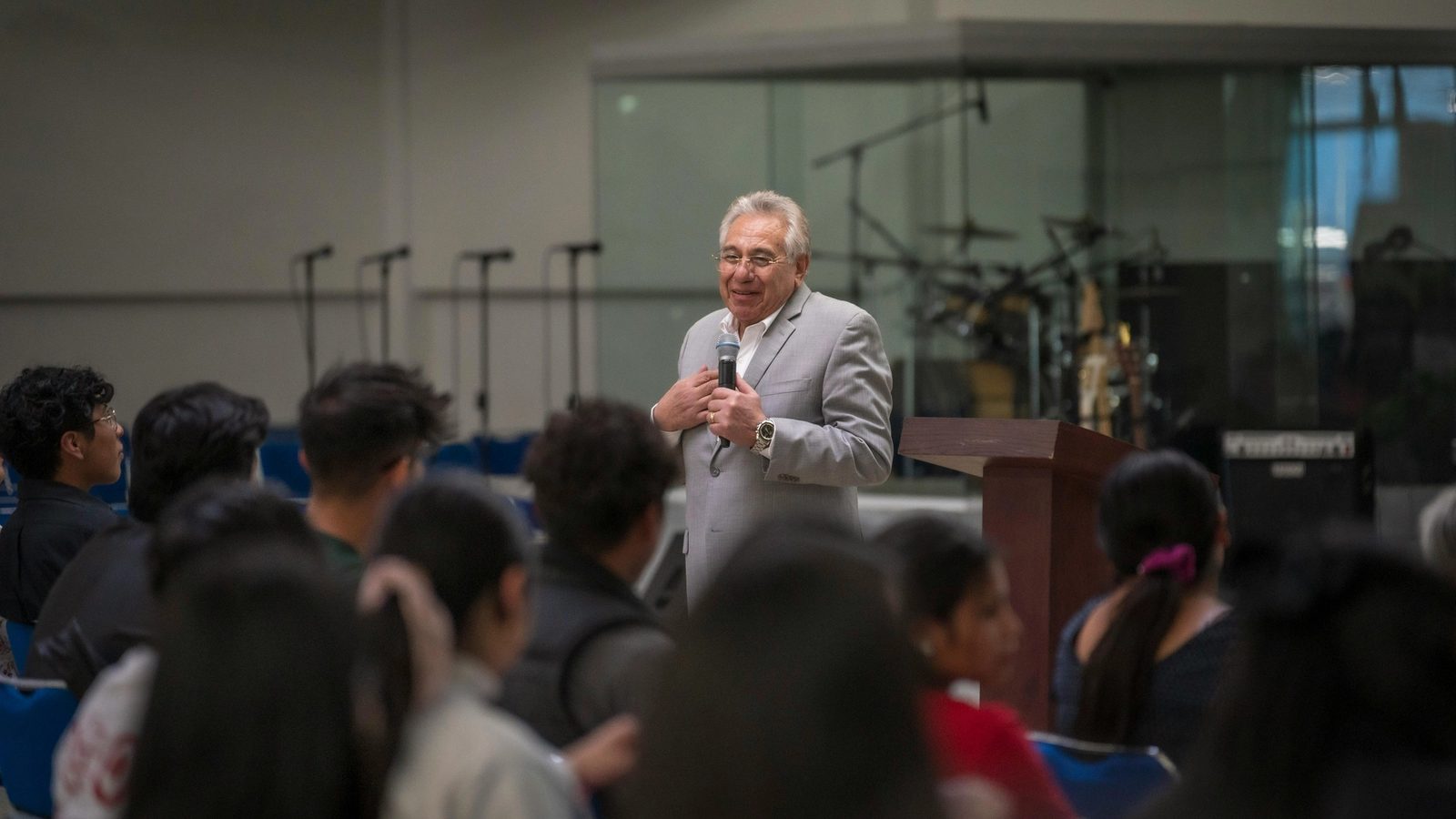 Main Image: Young People Listening to a Lecturer, and Sound Equipment in Background