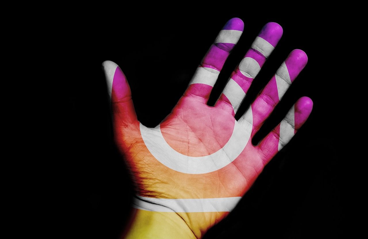 A person's palm with the Instagram icon painted on