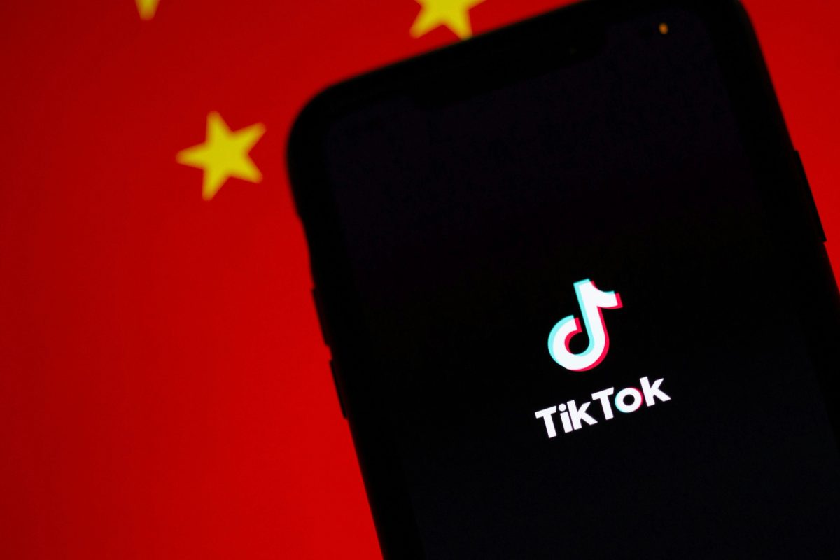TikTok running on iPhone with a Chinese flag in the background
