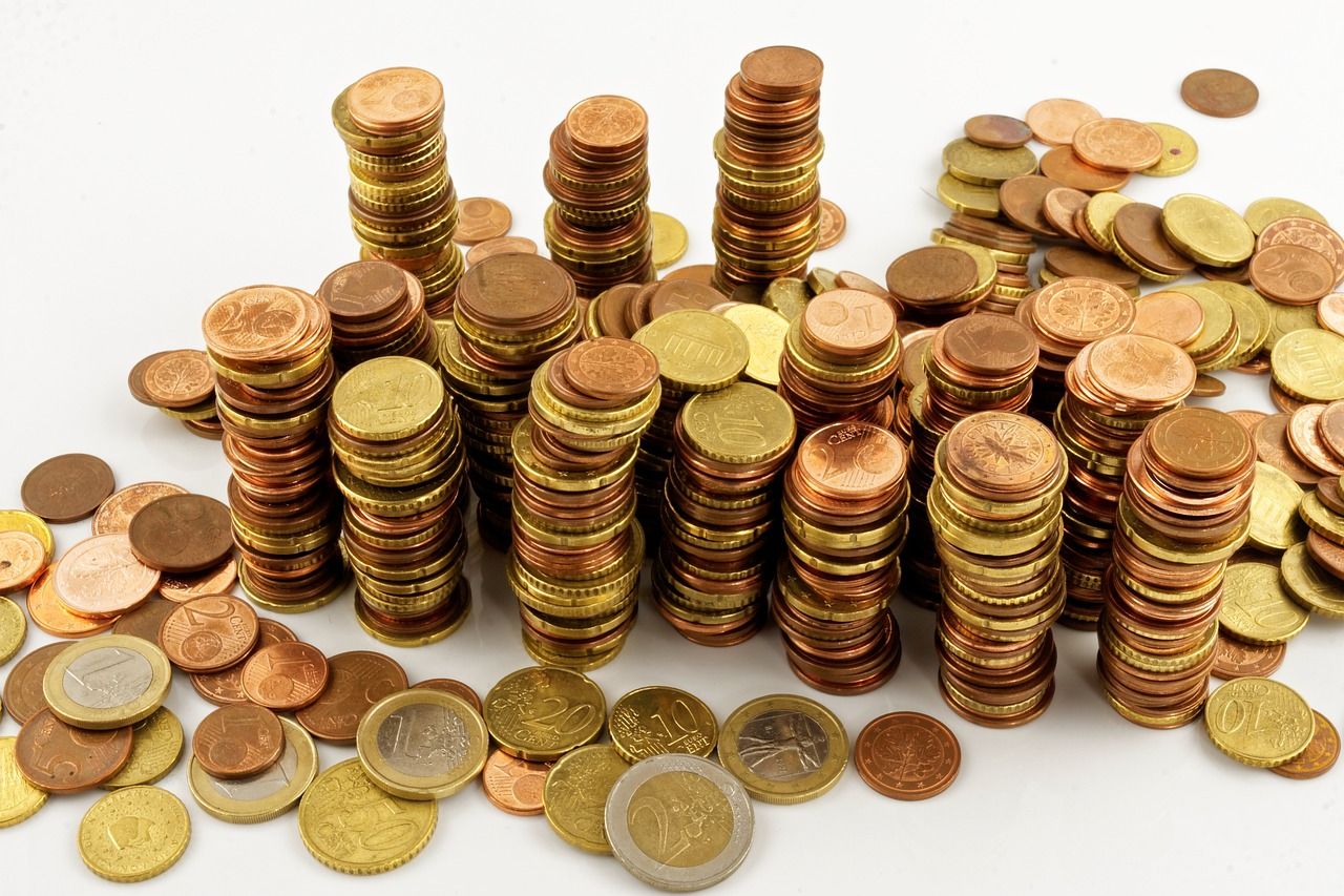 Euro coins in piles signifying tough economic times