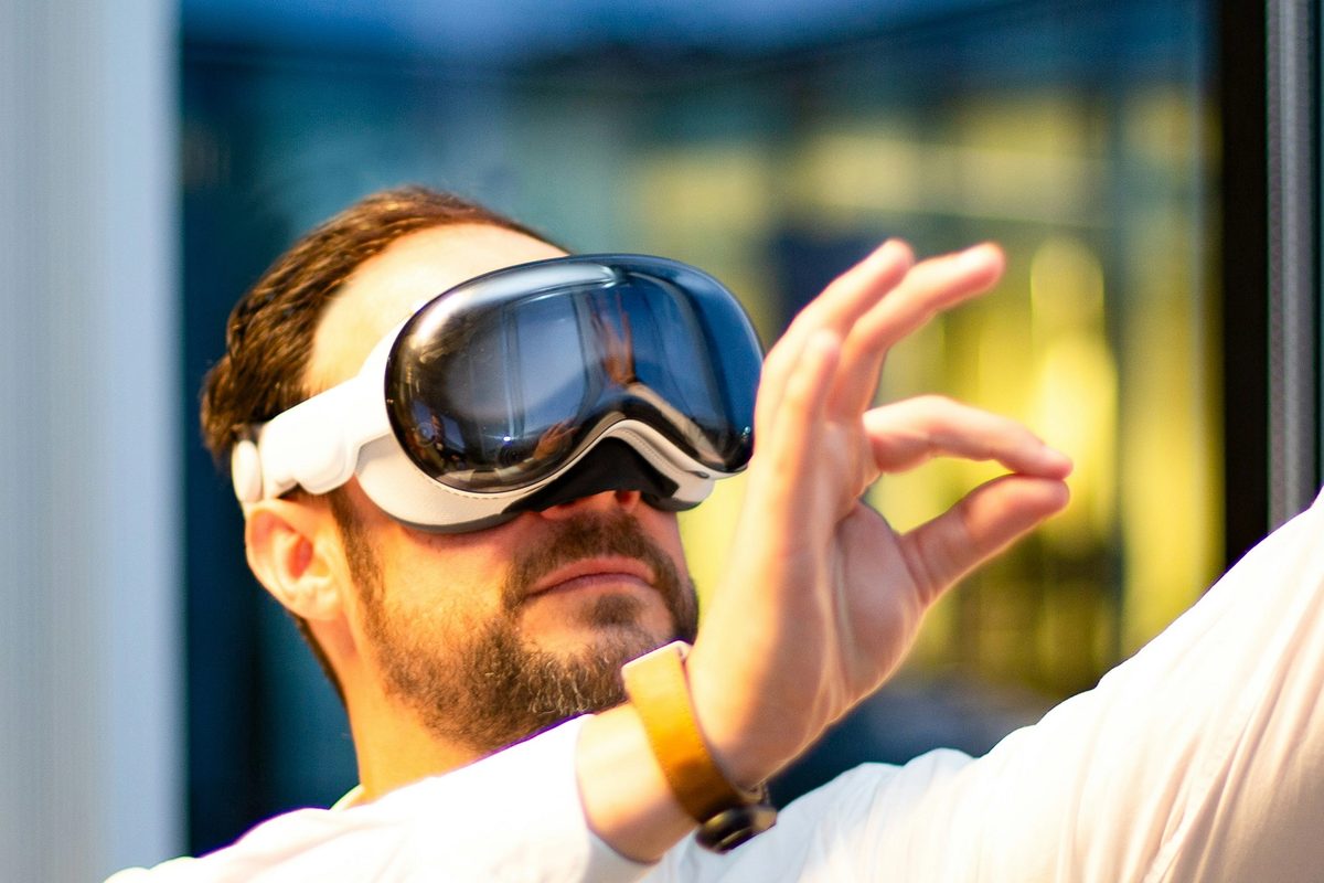 Apple Vision Pro with pinching gesture in professional setting in the evening