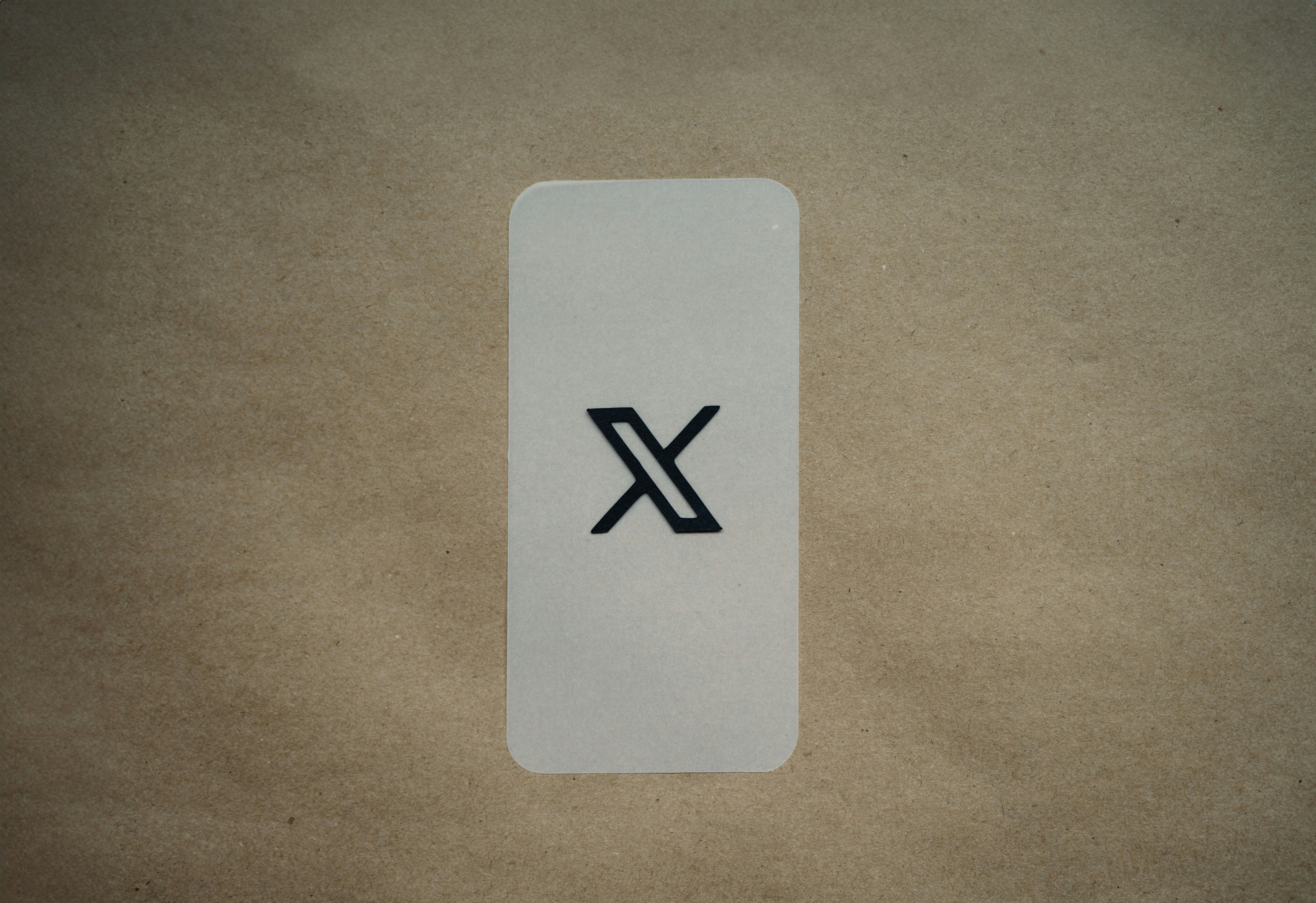 A photo of a sticker containing the X icon