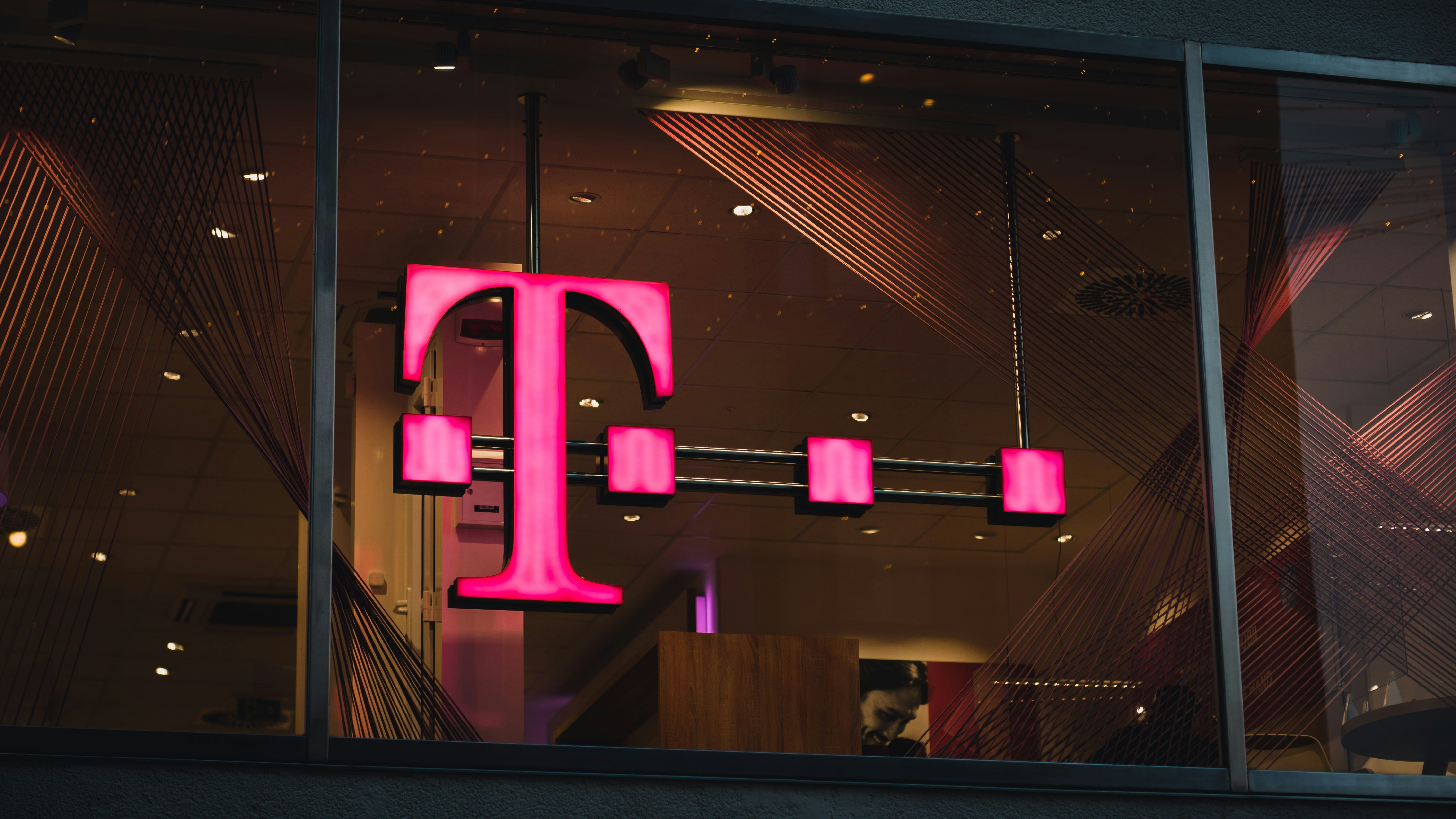 Main Image: T-Mobile logo on the window of a building