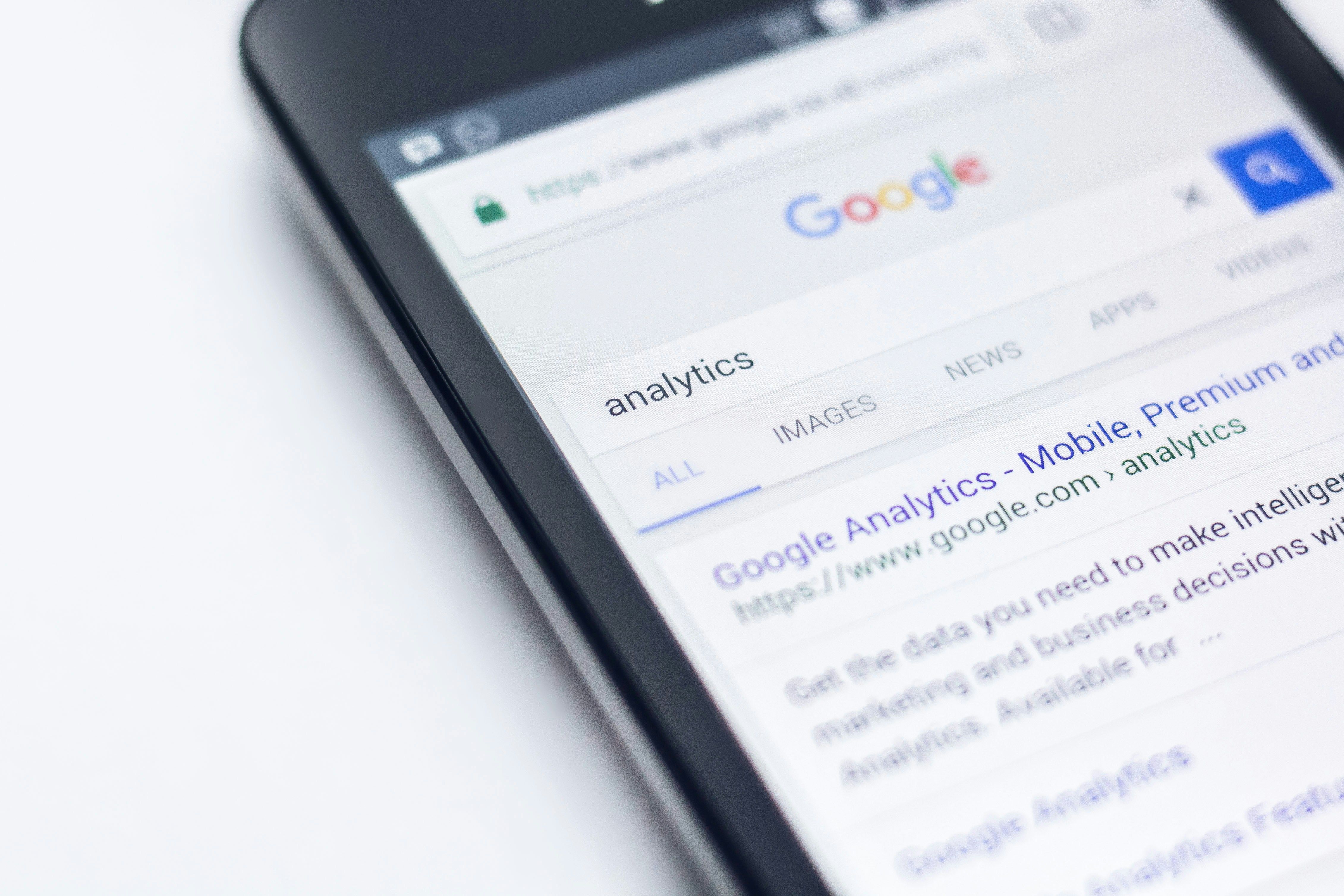 Smartphone showing Google search results for 'analytics'