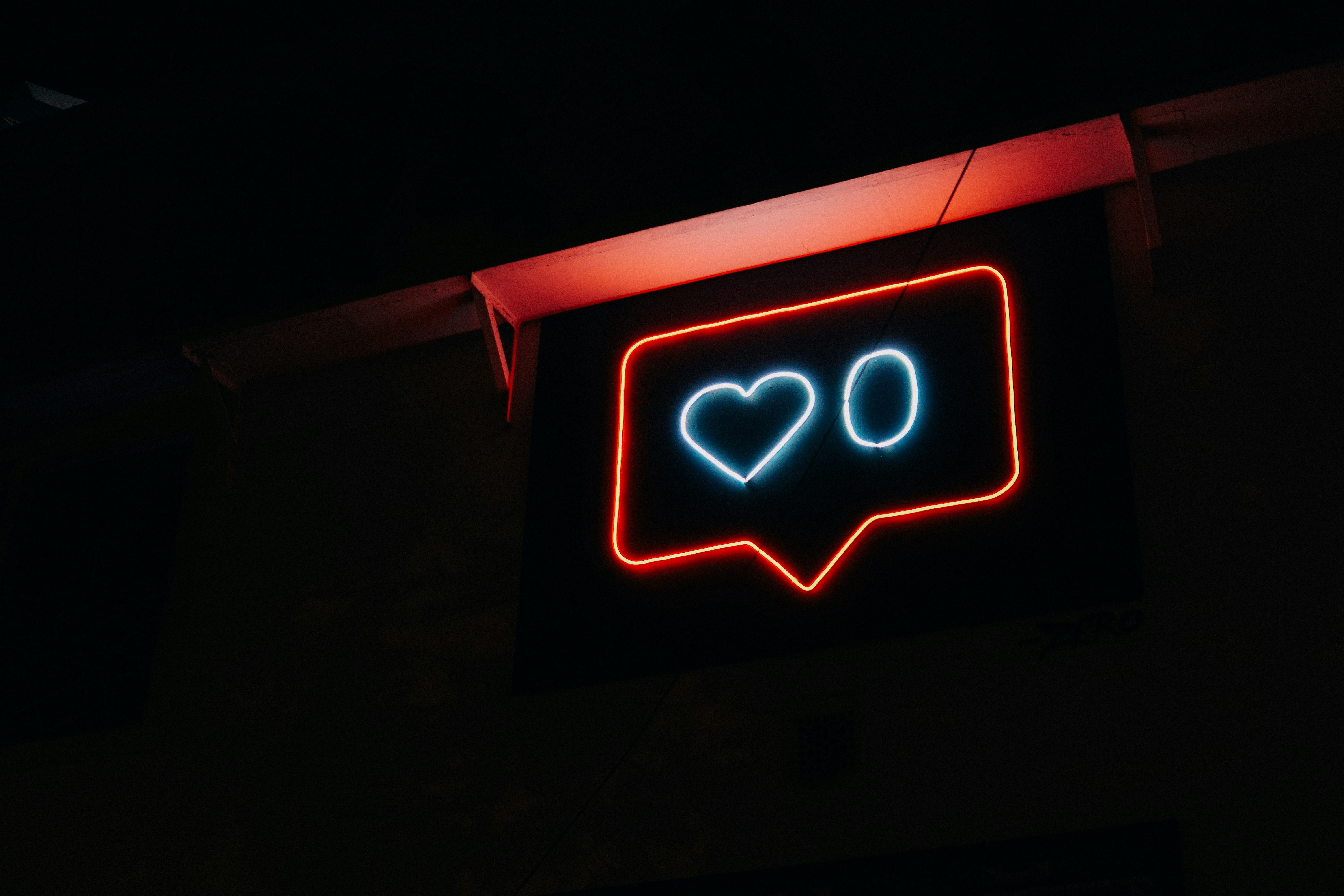 Main Image: Neon sign of an Instagram 'Like' icon showing zero likes