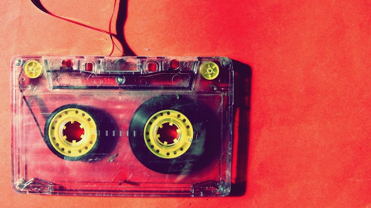 Main image. Cassette tape set against a red background.