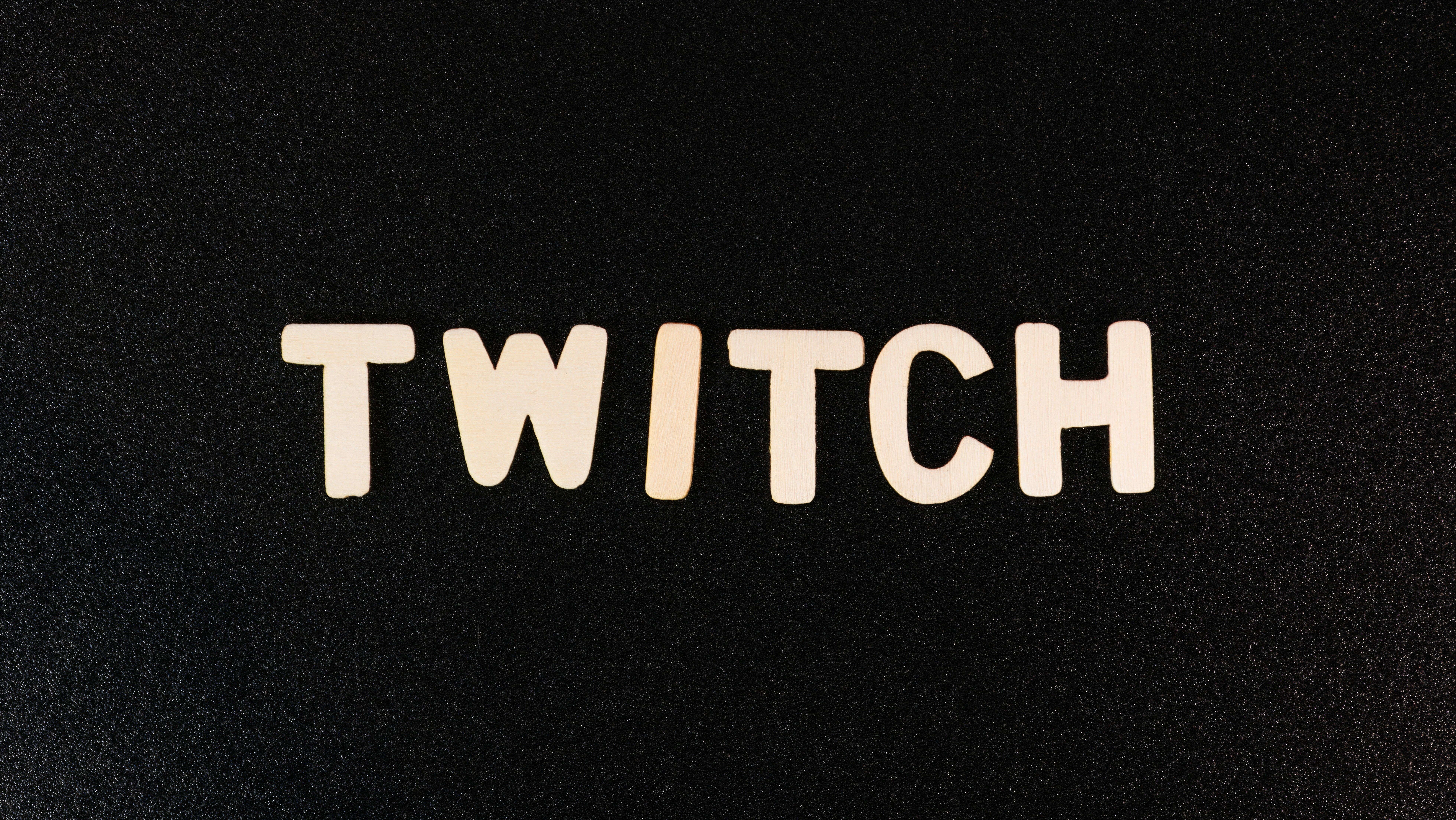 Main Image: The word "TWITCH" written in white type on a black surface