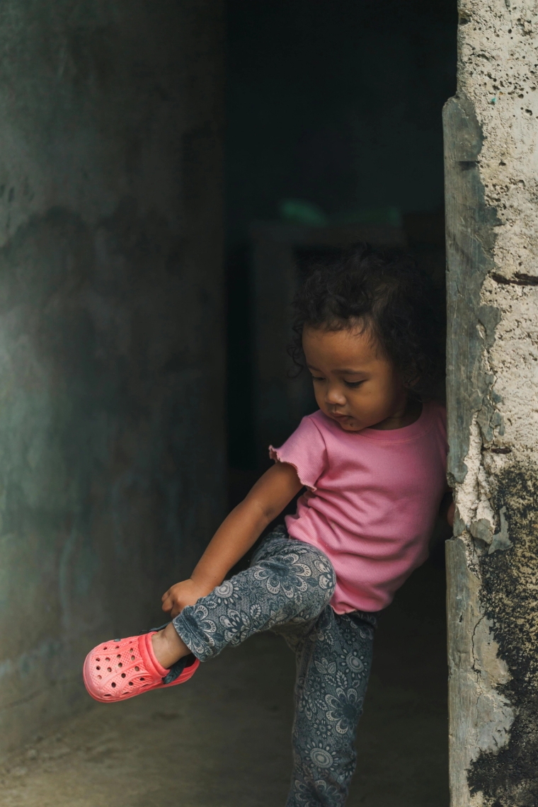 Child stepping out from a doorway