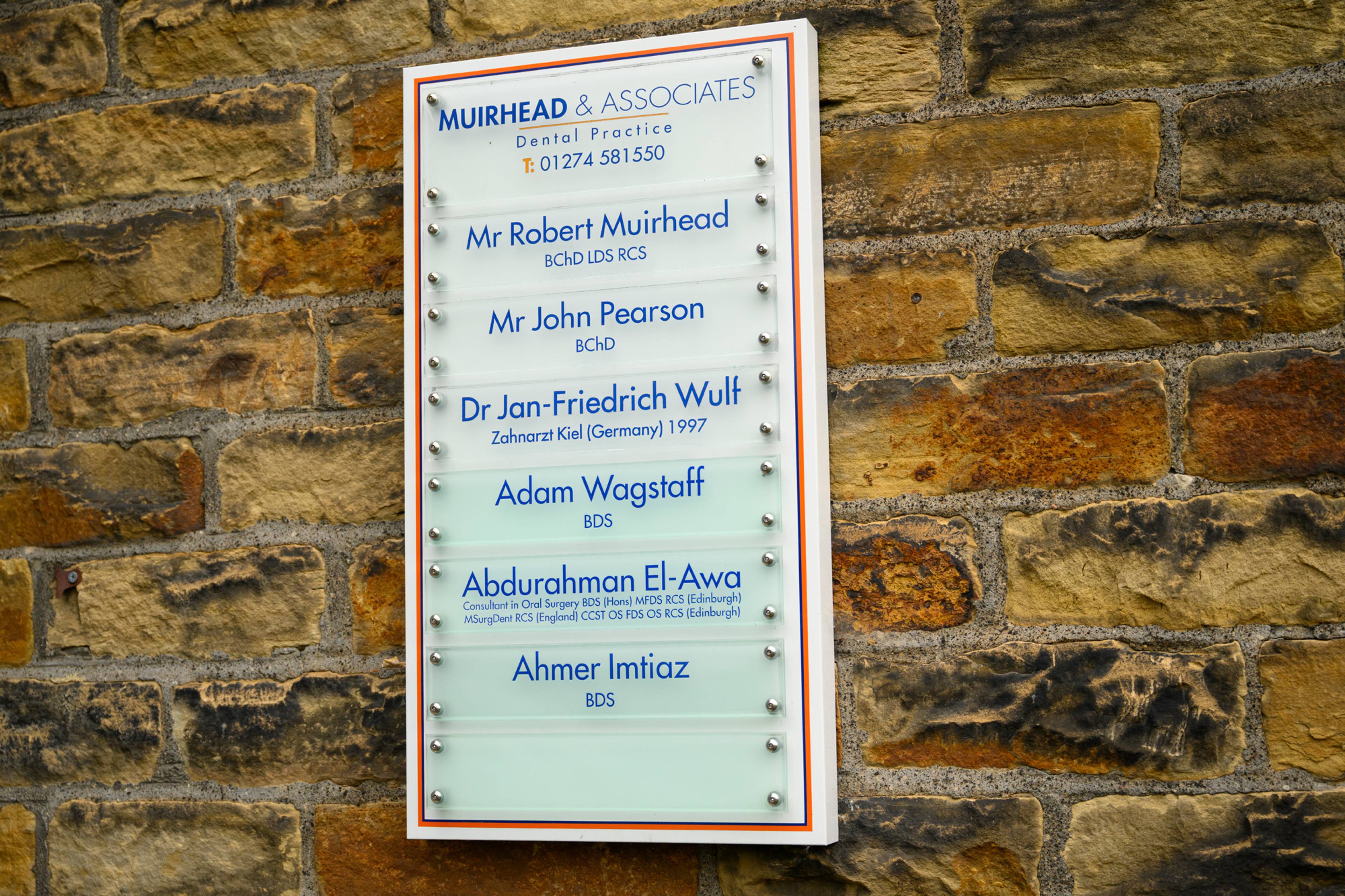 The sign outside our practice that lists all our dentists