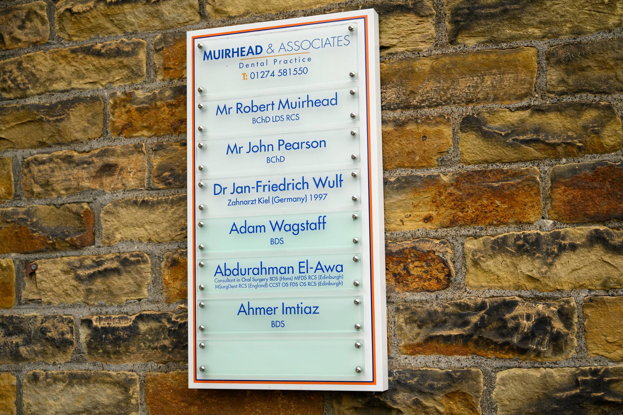 The sign outside our practice that lists all our dentists