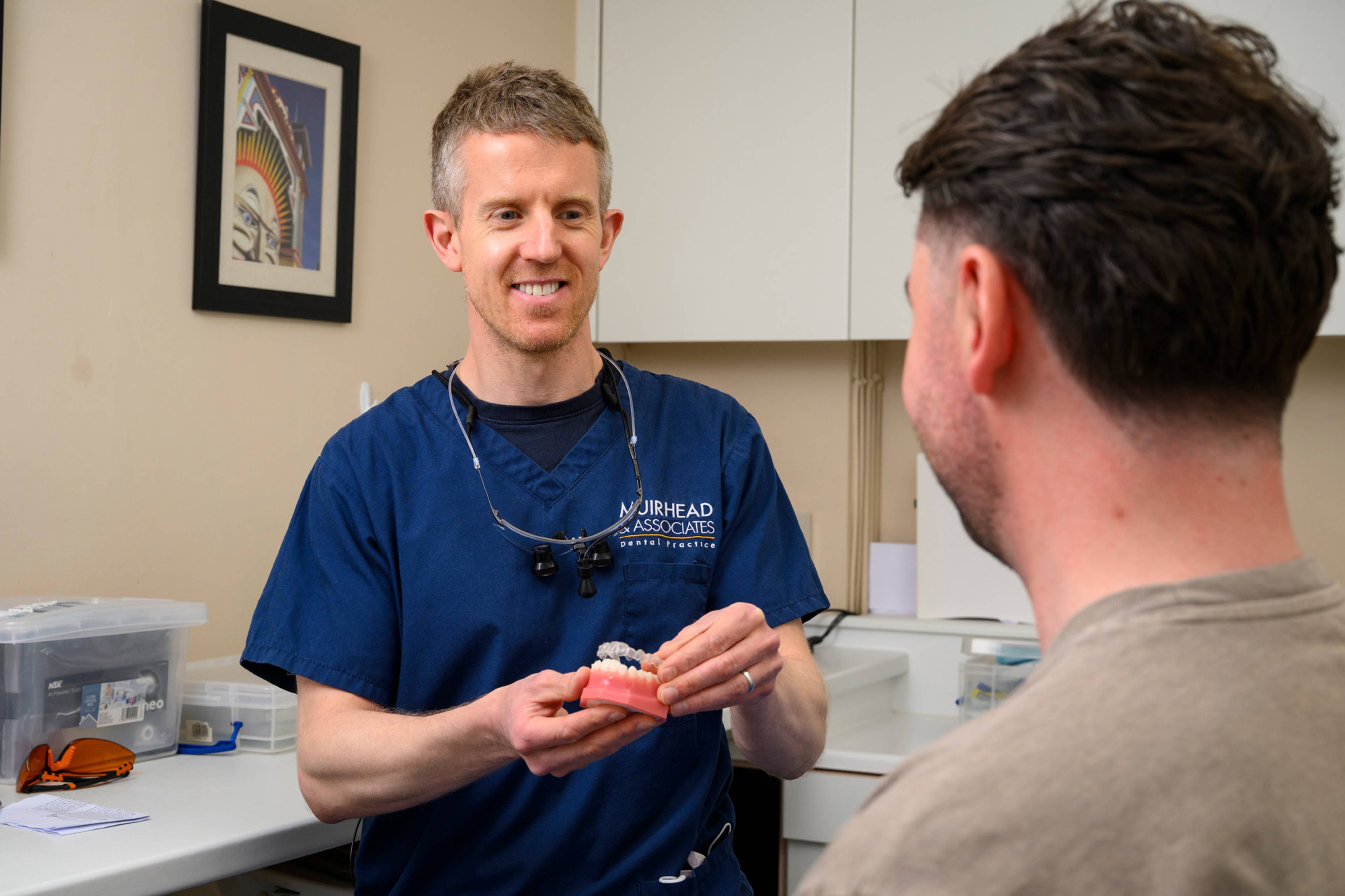 A member of the team shows how clear aligners work