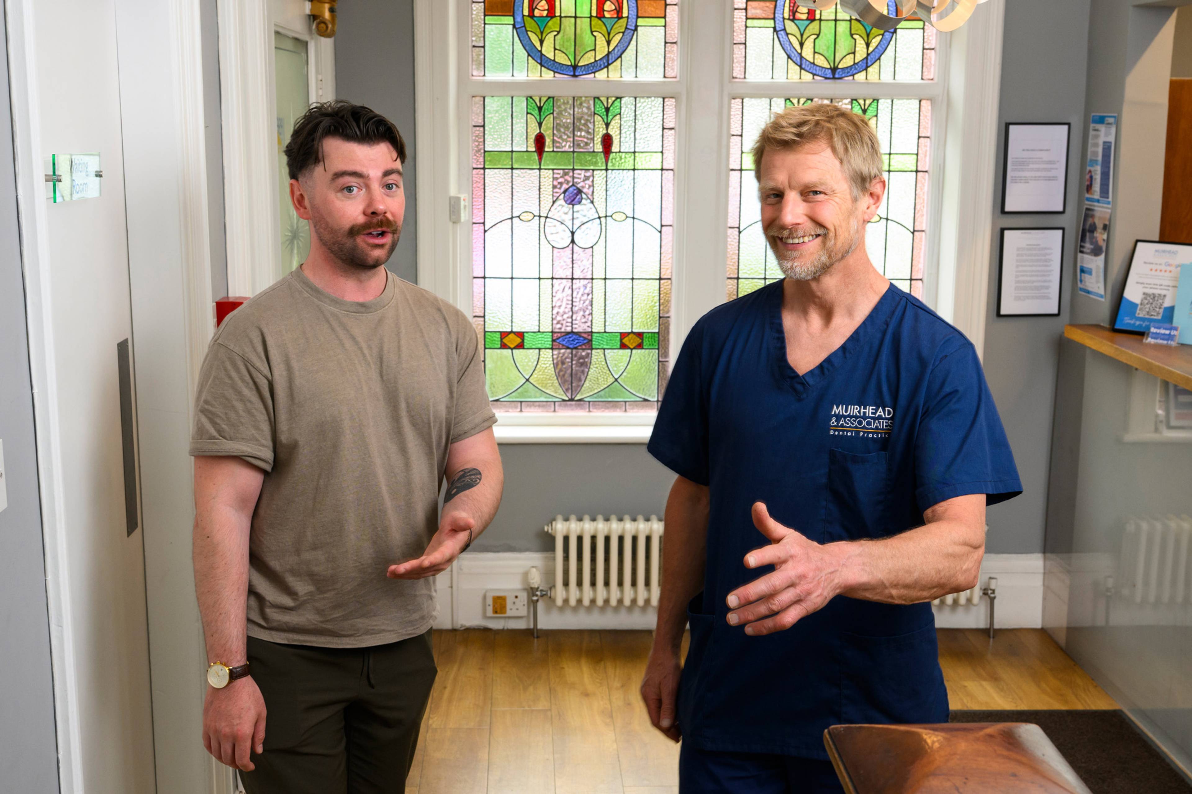 Robert Muirhead showing a patient around the practice
