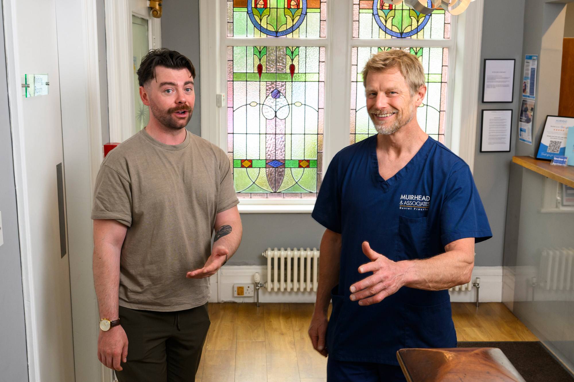 Robert Muirhead showing a patient around the practice