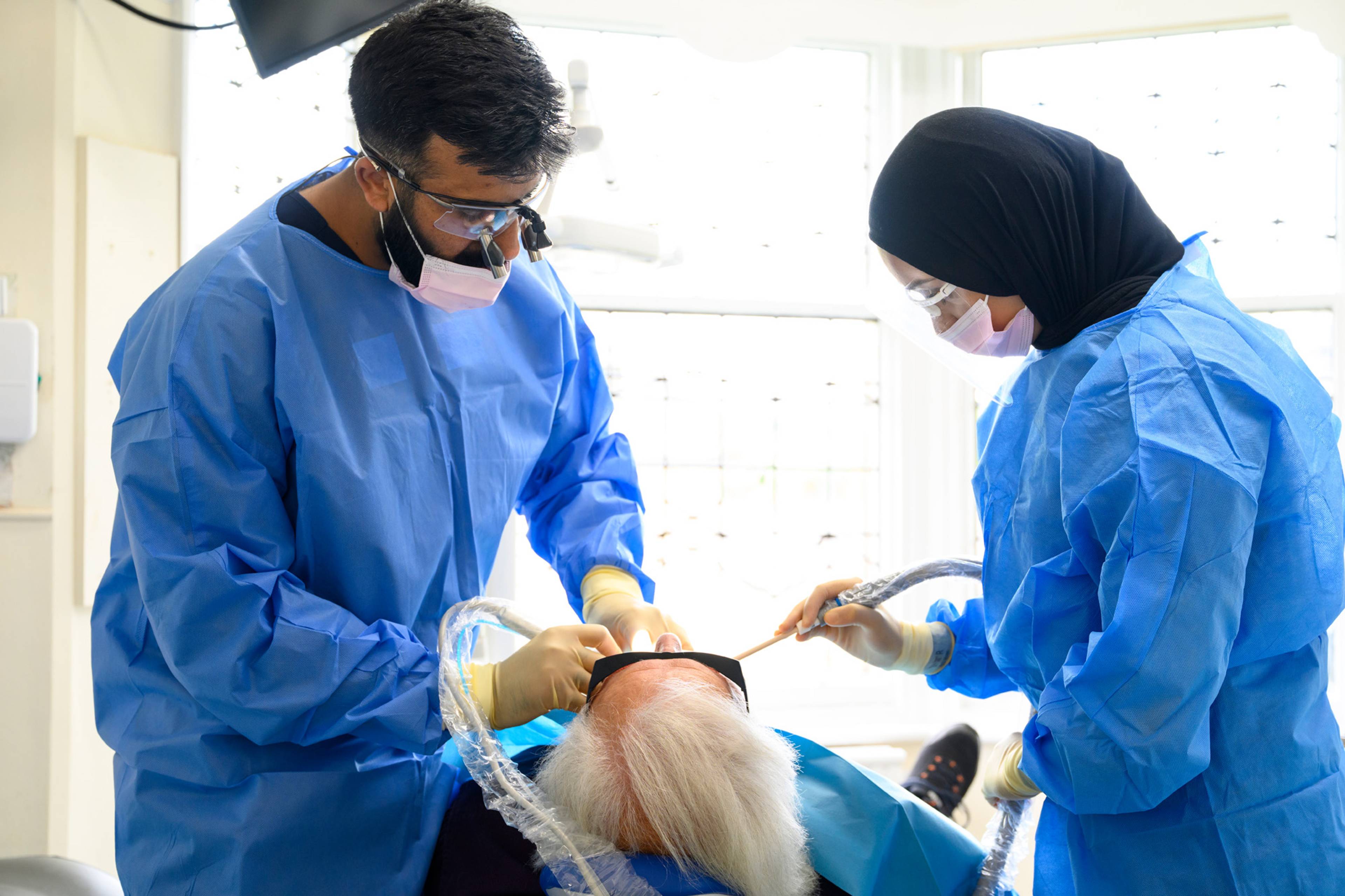 Ahmer and Shifah working on a patient