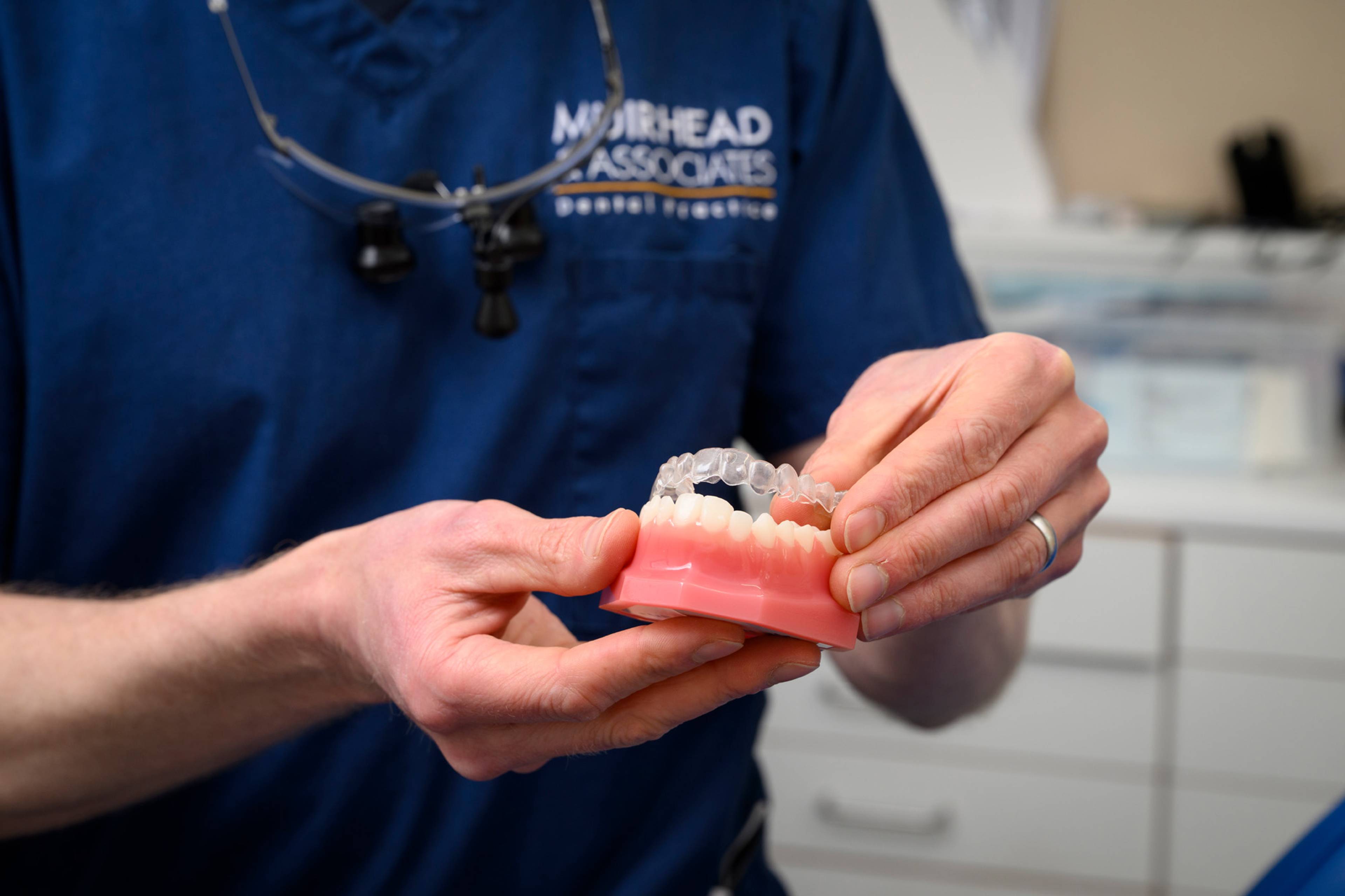 Chris demonstrates clear aligners on a model of a jaw