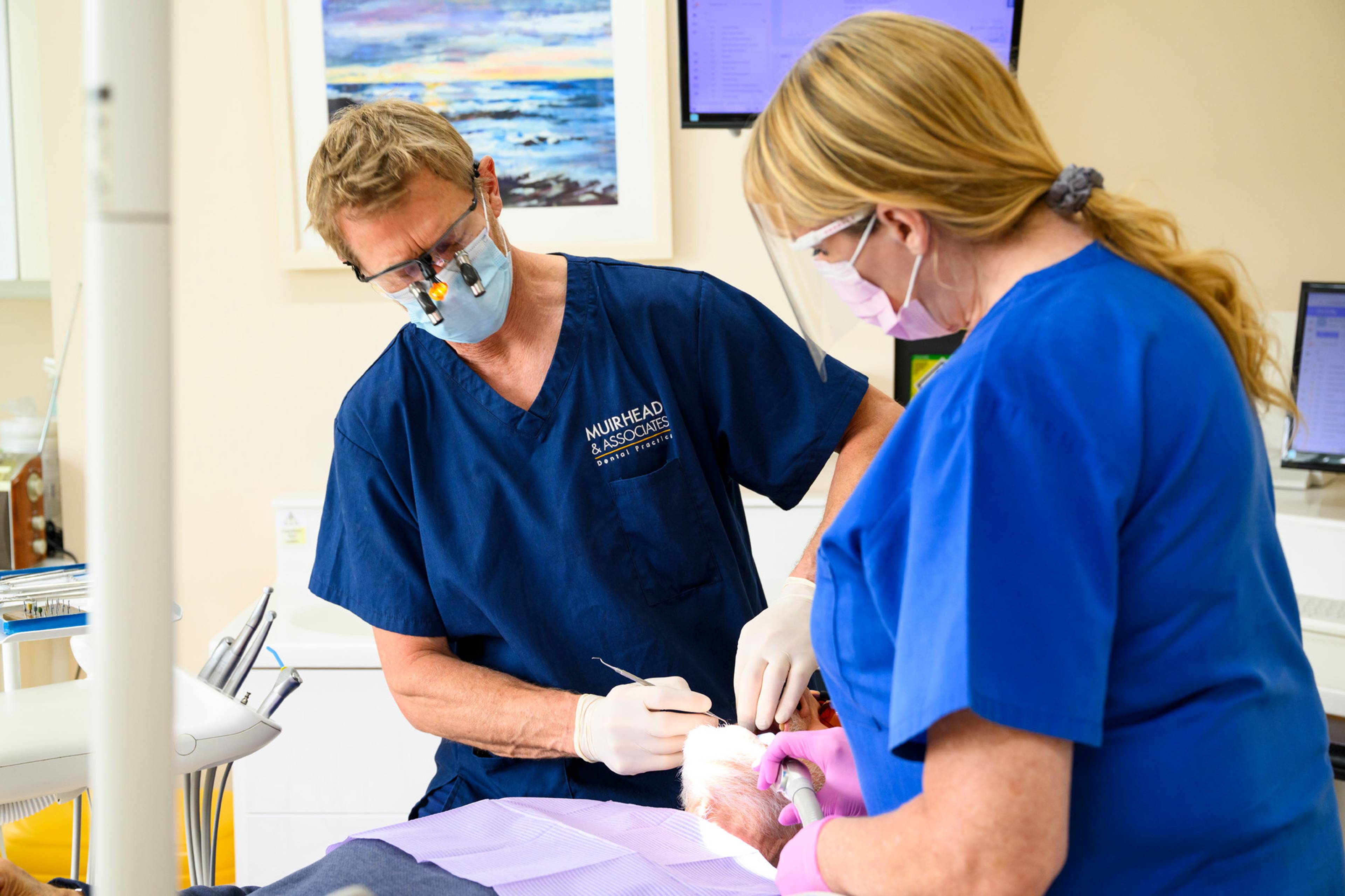Robert Muirhead works on a patient in a bright and welcoming treatment room
