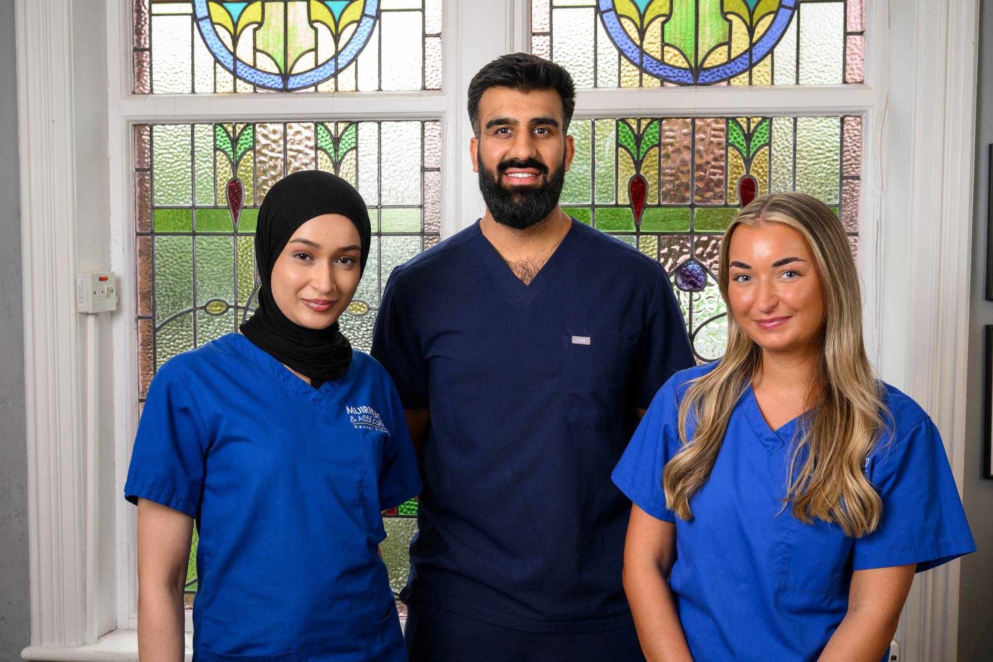 Ahmer Imtiaz with two dental nurses