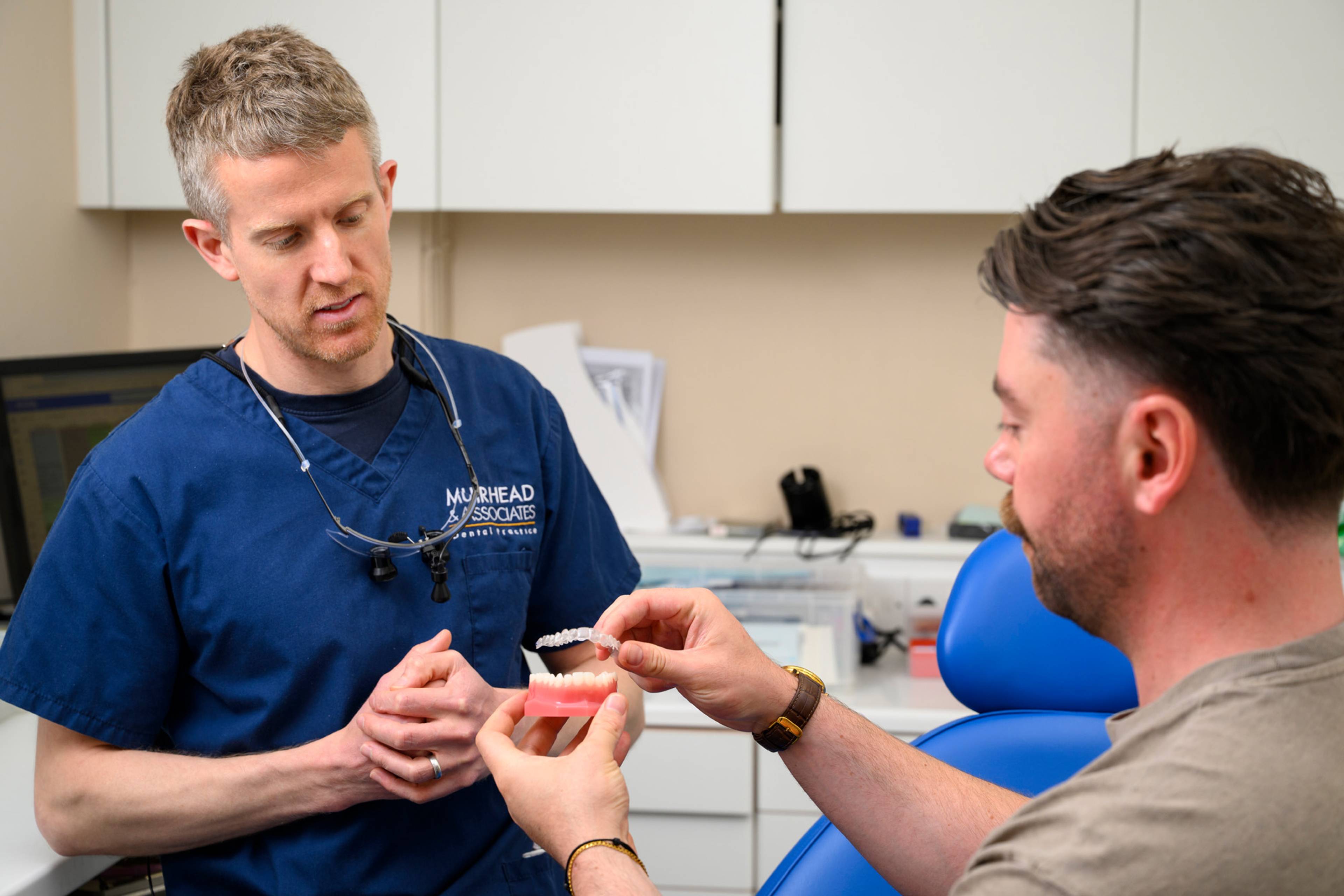 Adam Wagstaff showing a clear aligner model to a patient