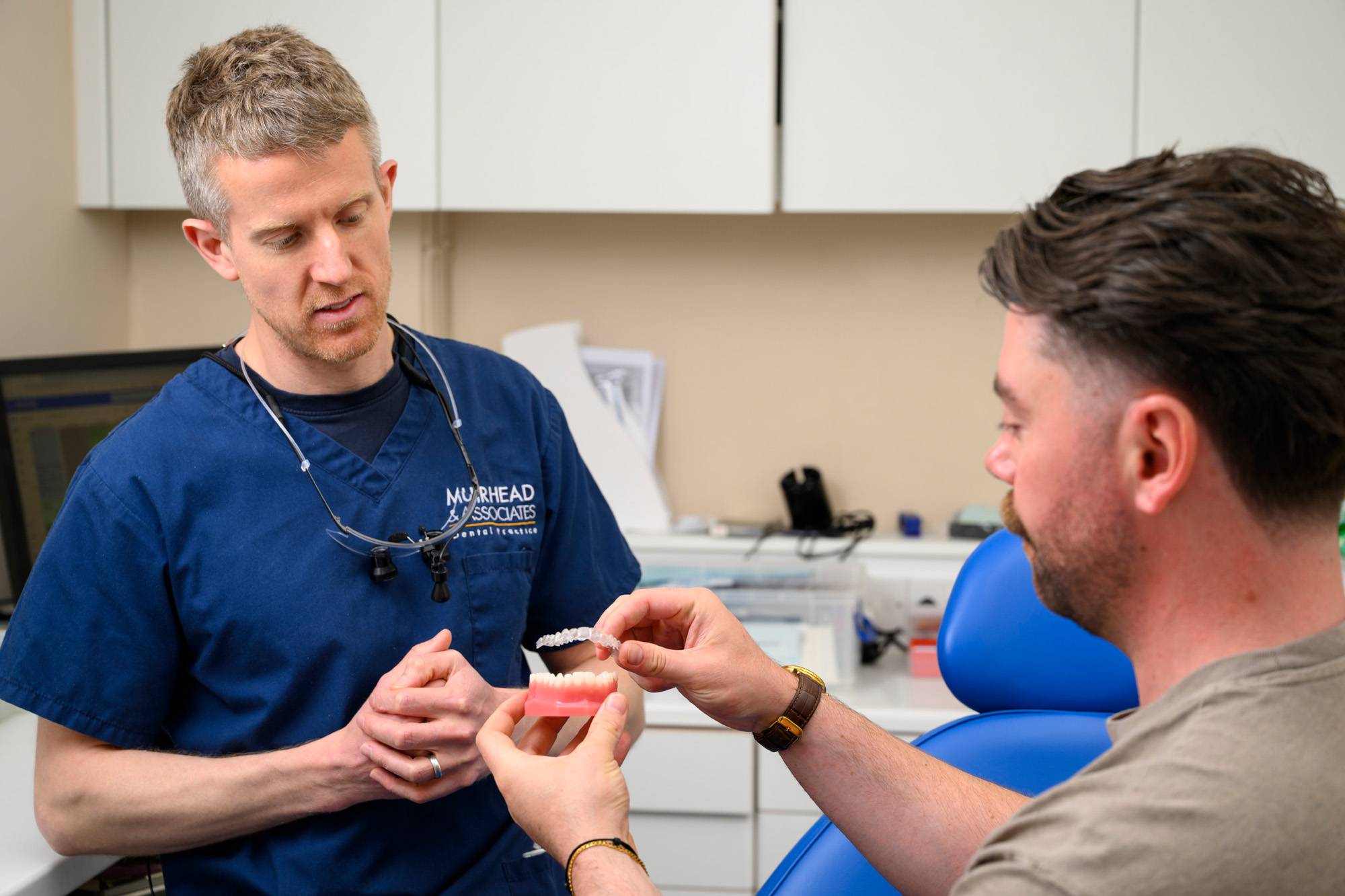 Adam Wagstaff showing a clear aligner model to a patient