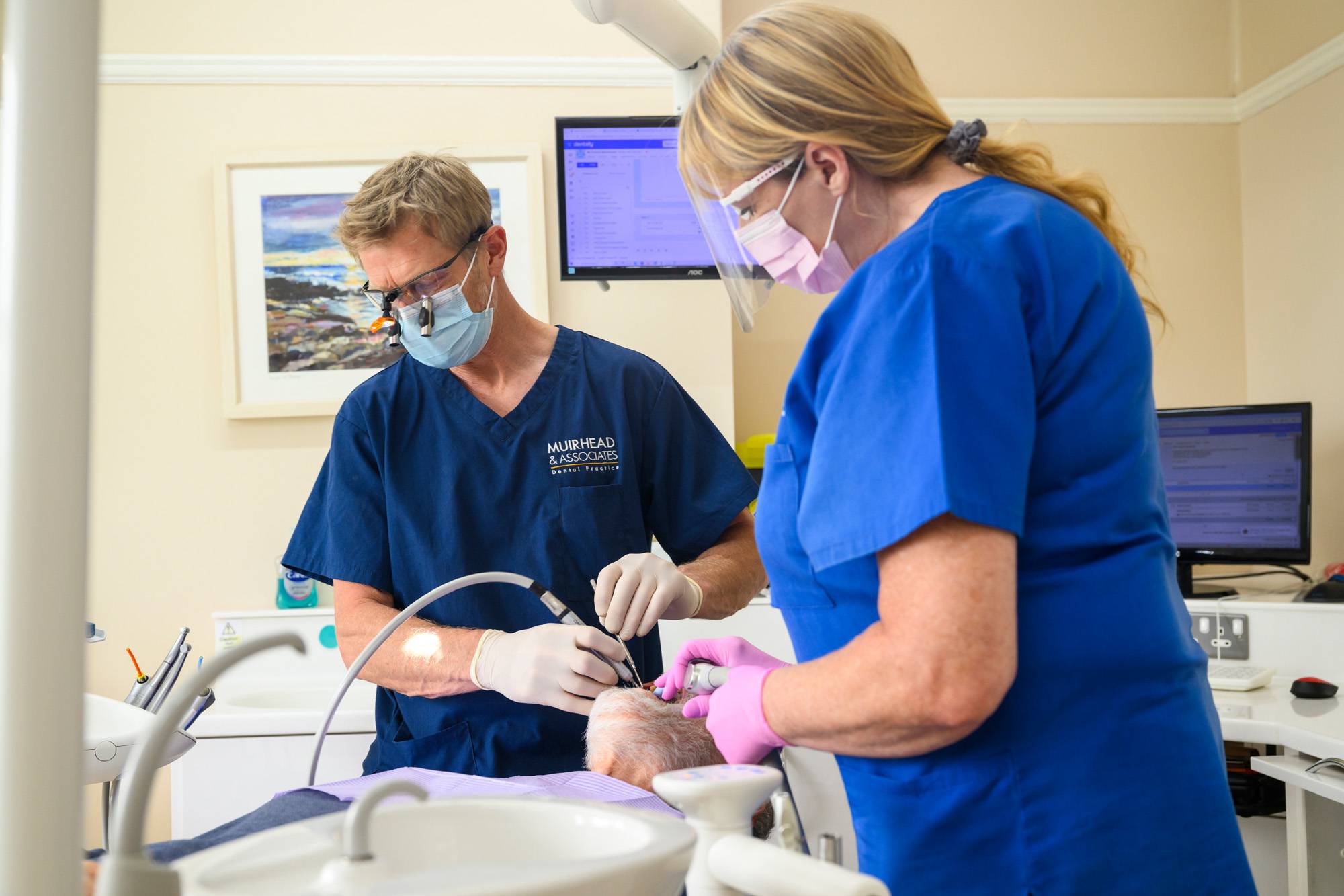 Rob Muirhead working on a patient's teeth