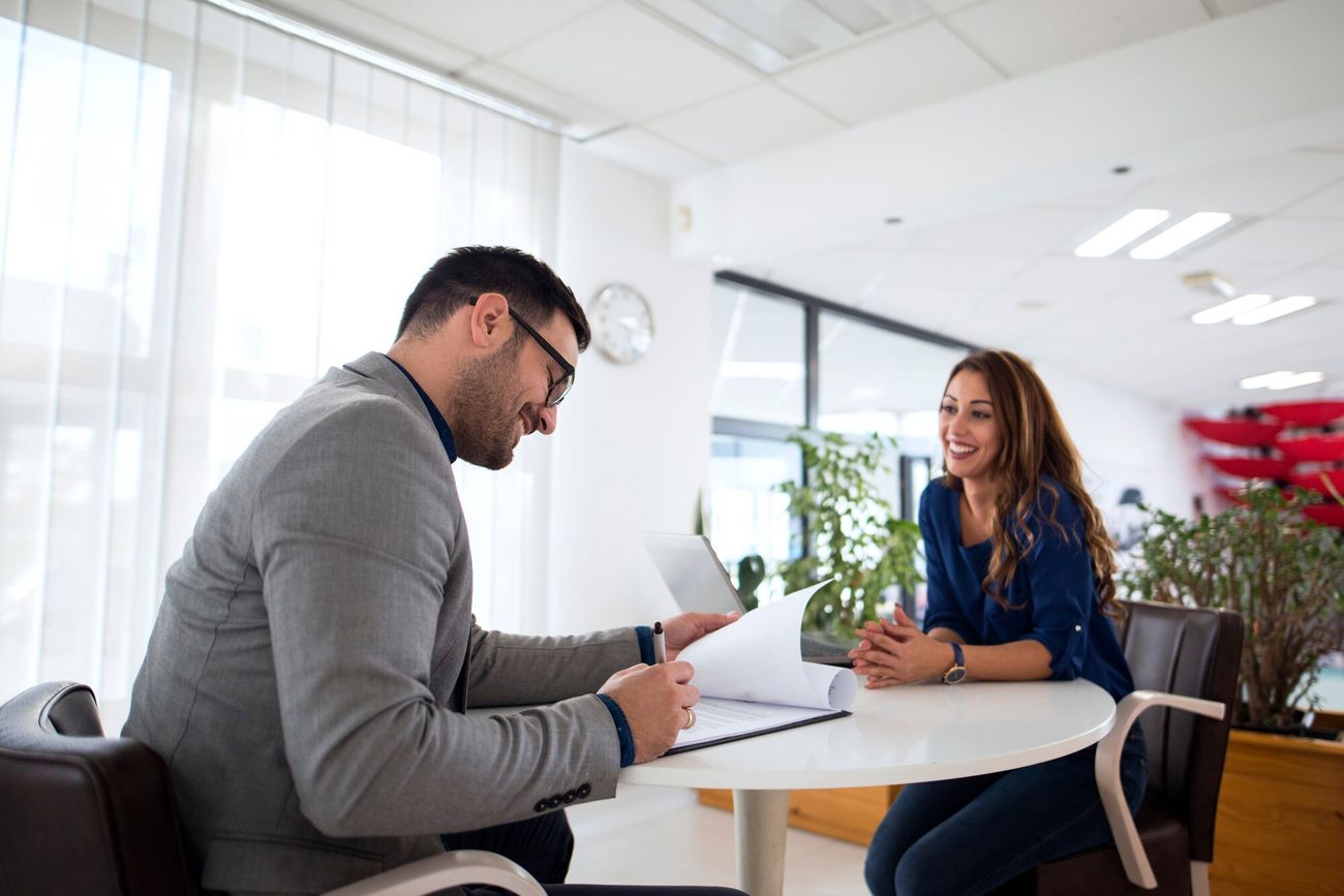 Two people engaged in conversation during an exit interview, demonstrating active listening