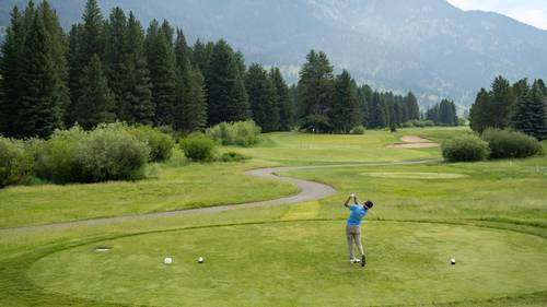 Golfer teeing off
