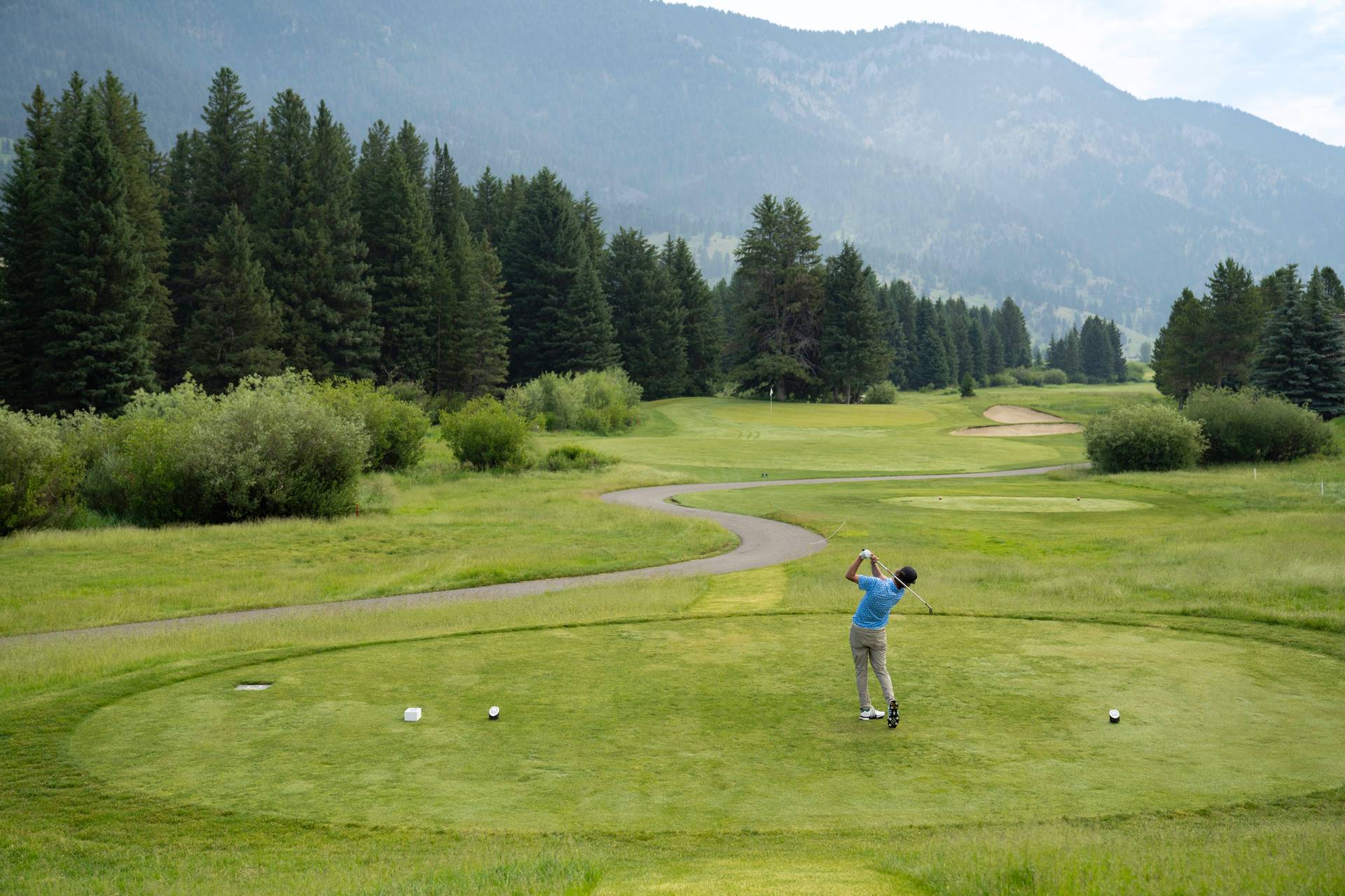 Golfer teeing off