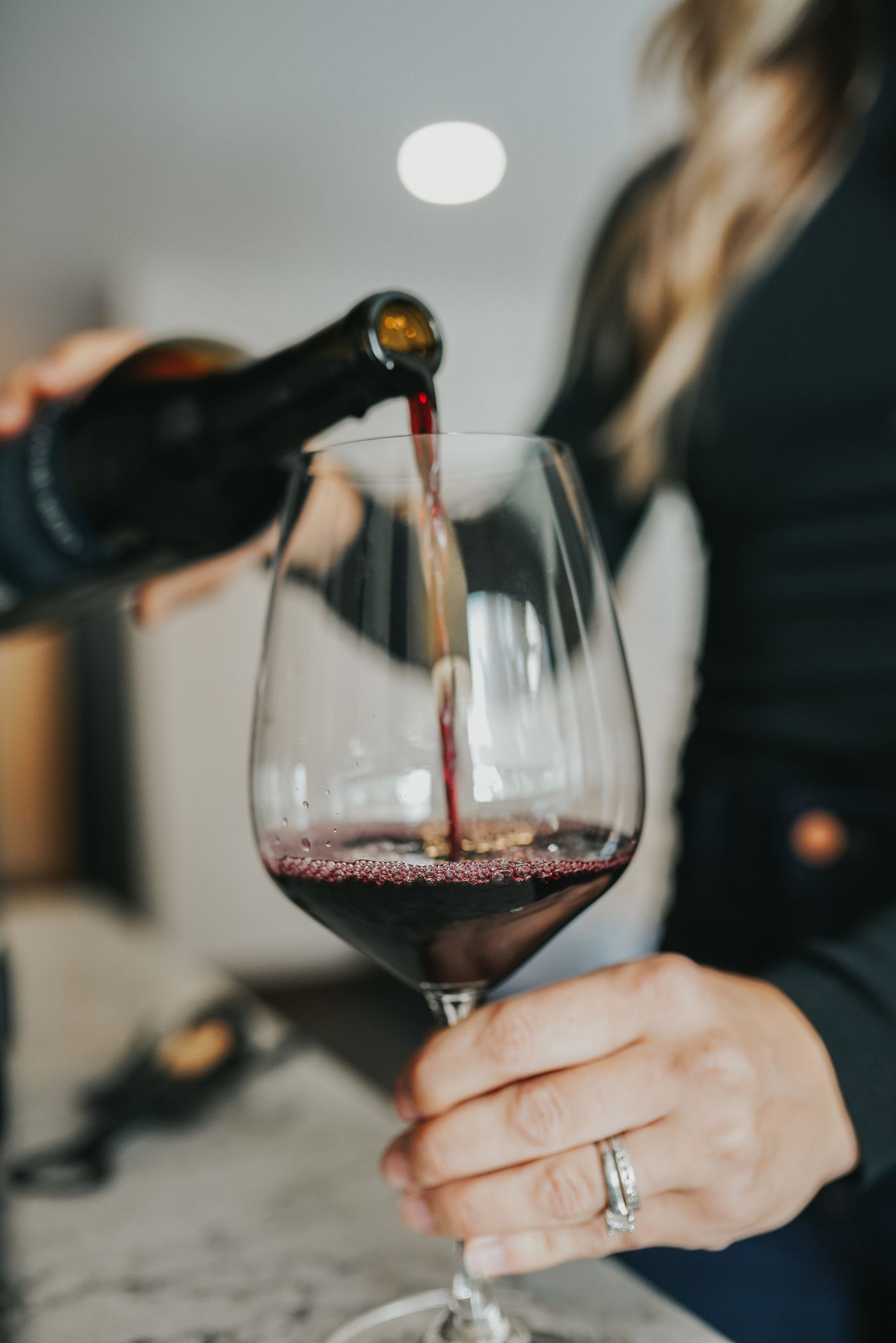 Woman pouring a glass of wine