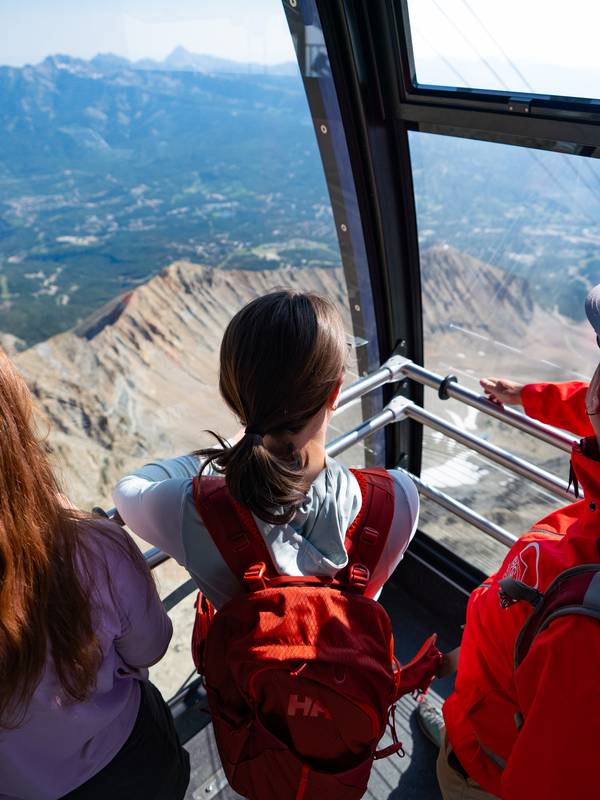 Riders on the Lone Peak Tram in summer