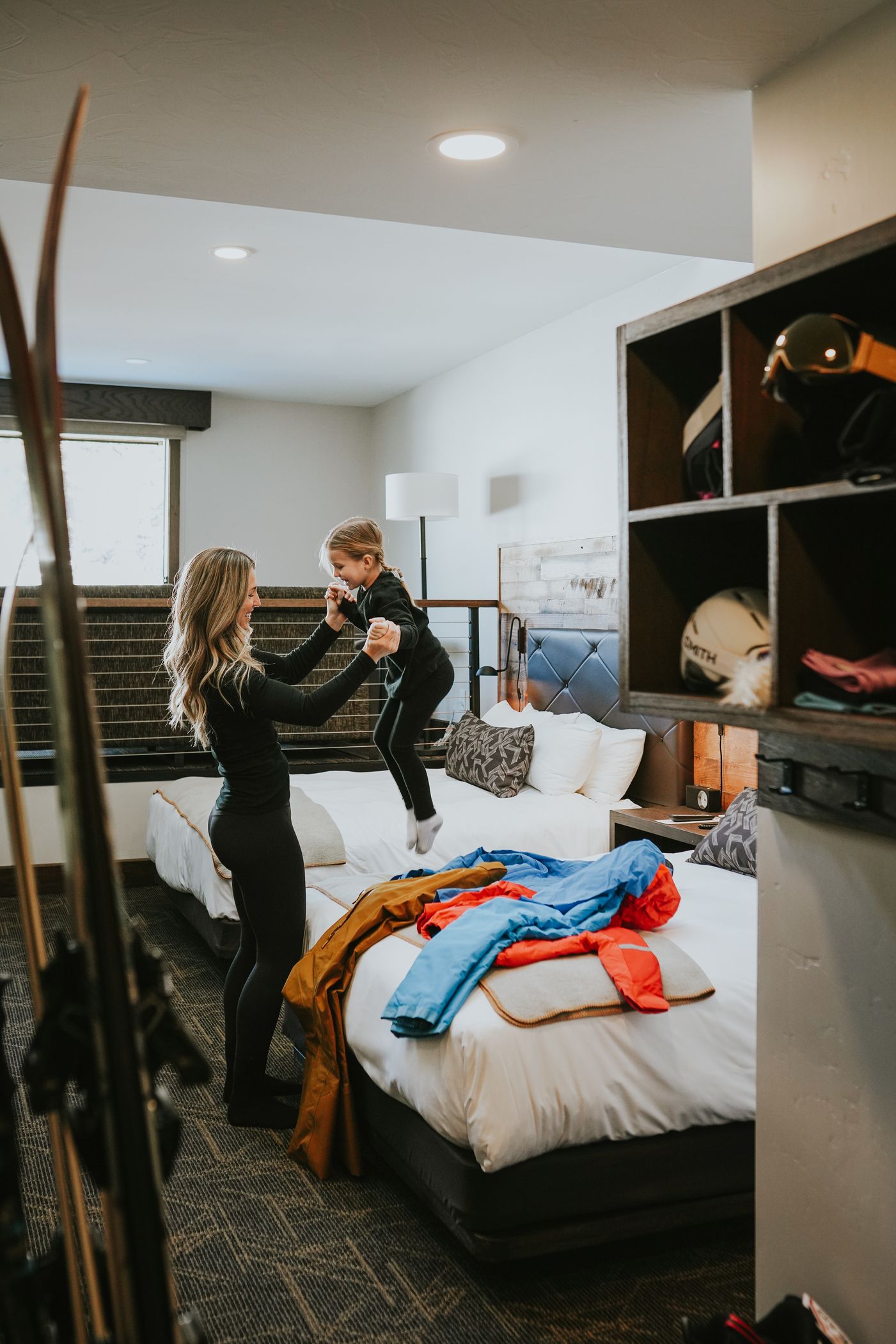 Mother and daughter getting dressed to ski in the Huntley Lodge