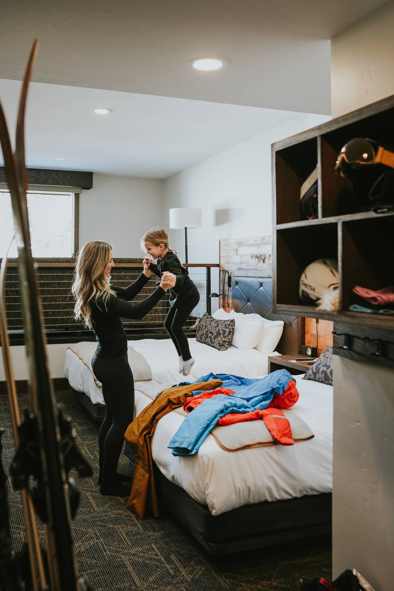 A woman and her daughter getting ready to ski in the Huntley Lodge