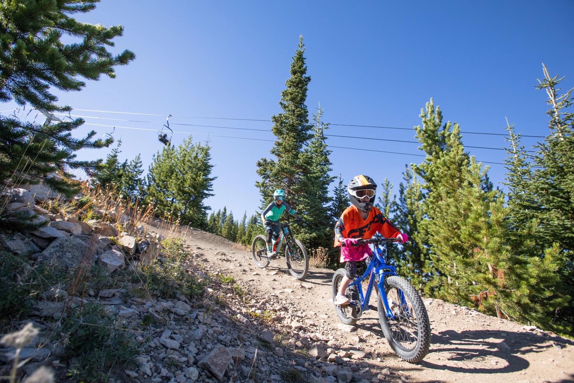 Girl and a parent riding mountain bikes